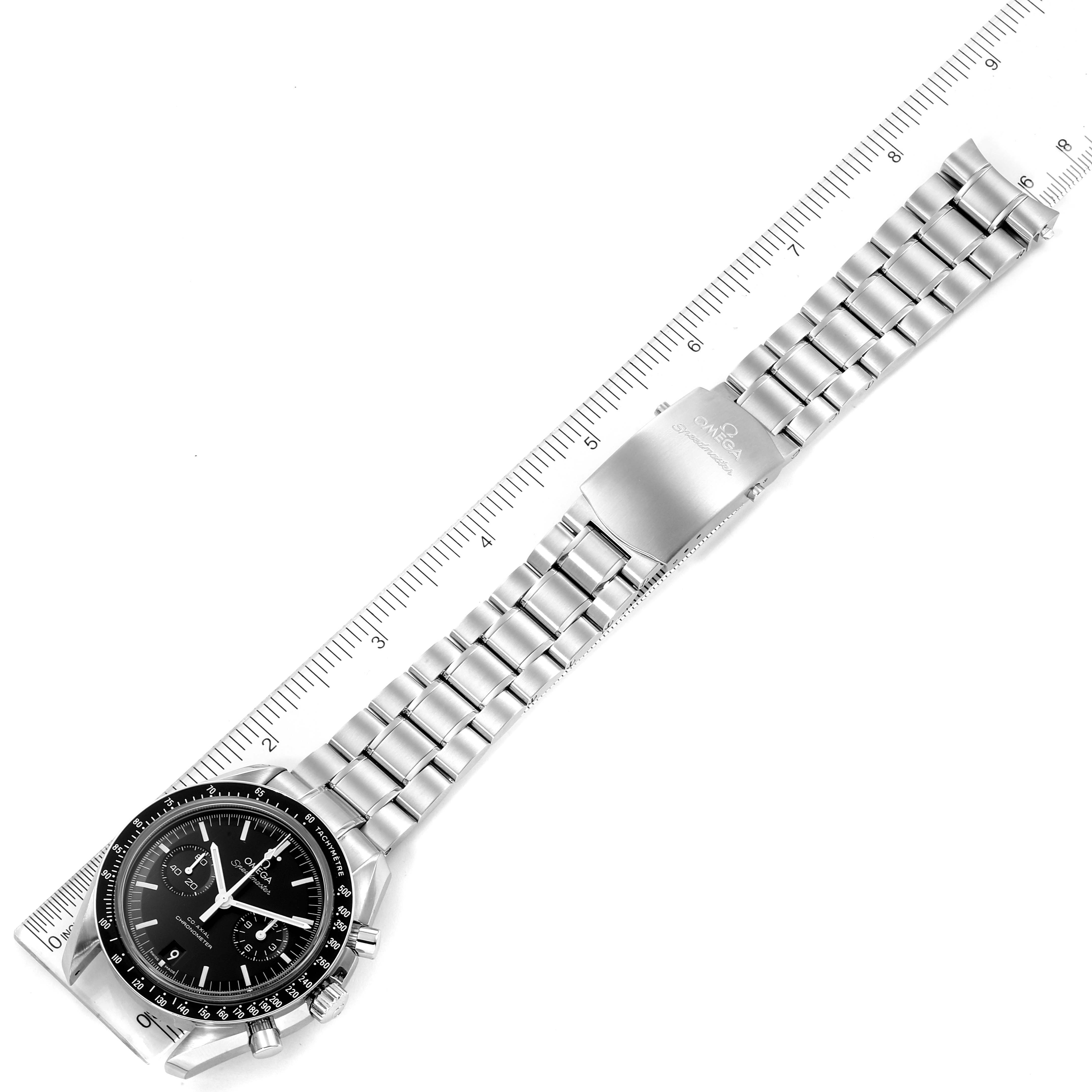 The image shows an Omega Speedmaster 311.30.44.51.01.002 Men
s Stainless Steel Black Dial 311.30.44.51.01.002 Men
s Stainless Steel Black Dial watch laid flat, with the face, bezel, bracelet, and clasp visible, alongside a ruler for scale.