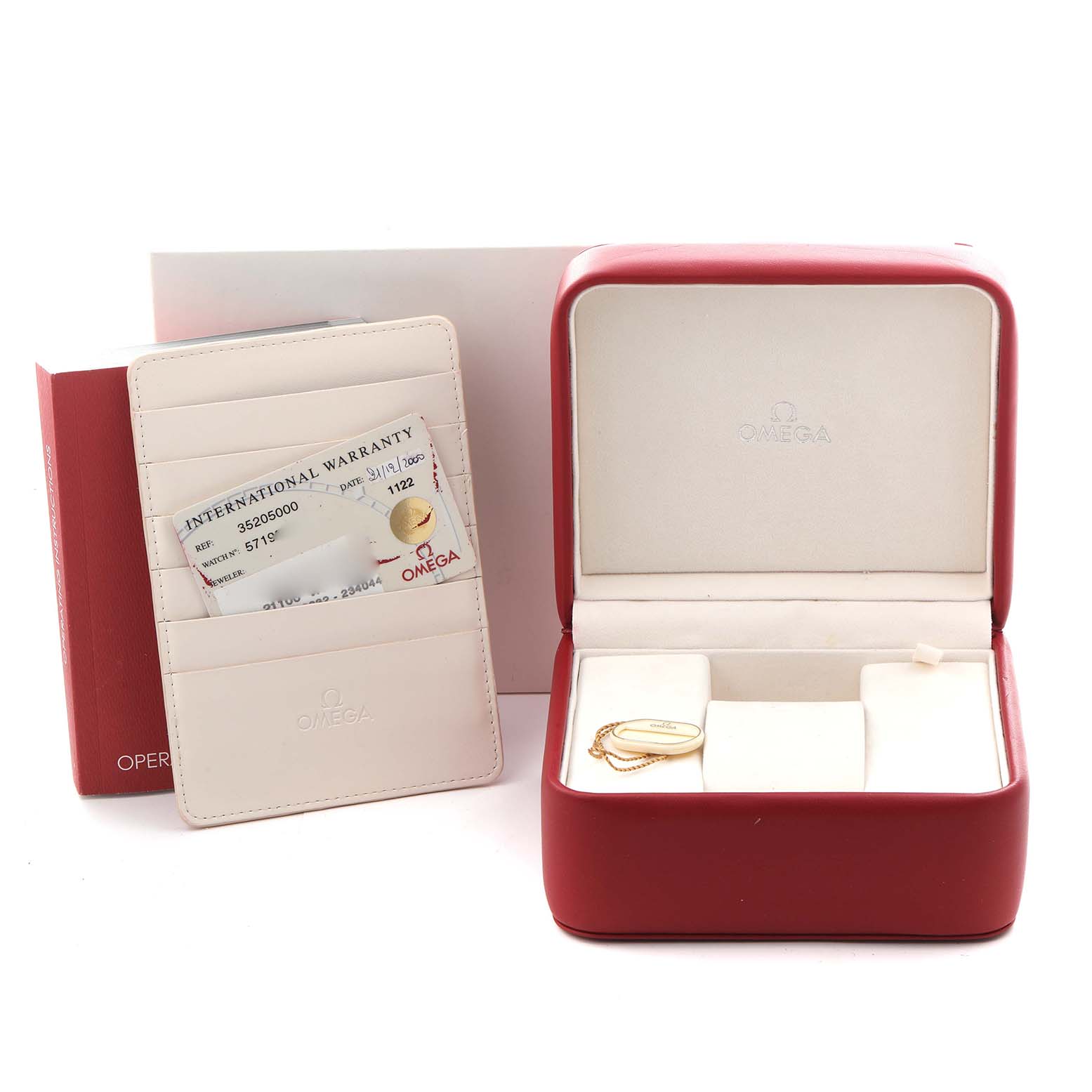 The image shows a red Omega Speedmaster 3520.50.00 Men's Stainless Steel Black Dial 3520.50.00 Men's Stainless Steel Black Dial box with an open lid, a warranty card holder, and an accessory tag, viewed from the front.