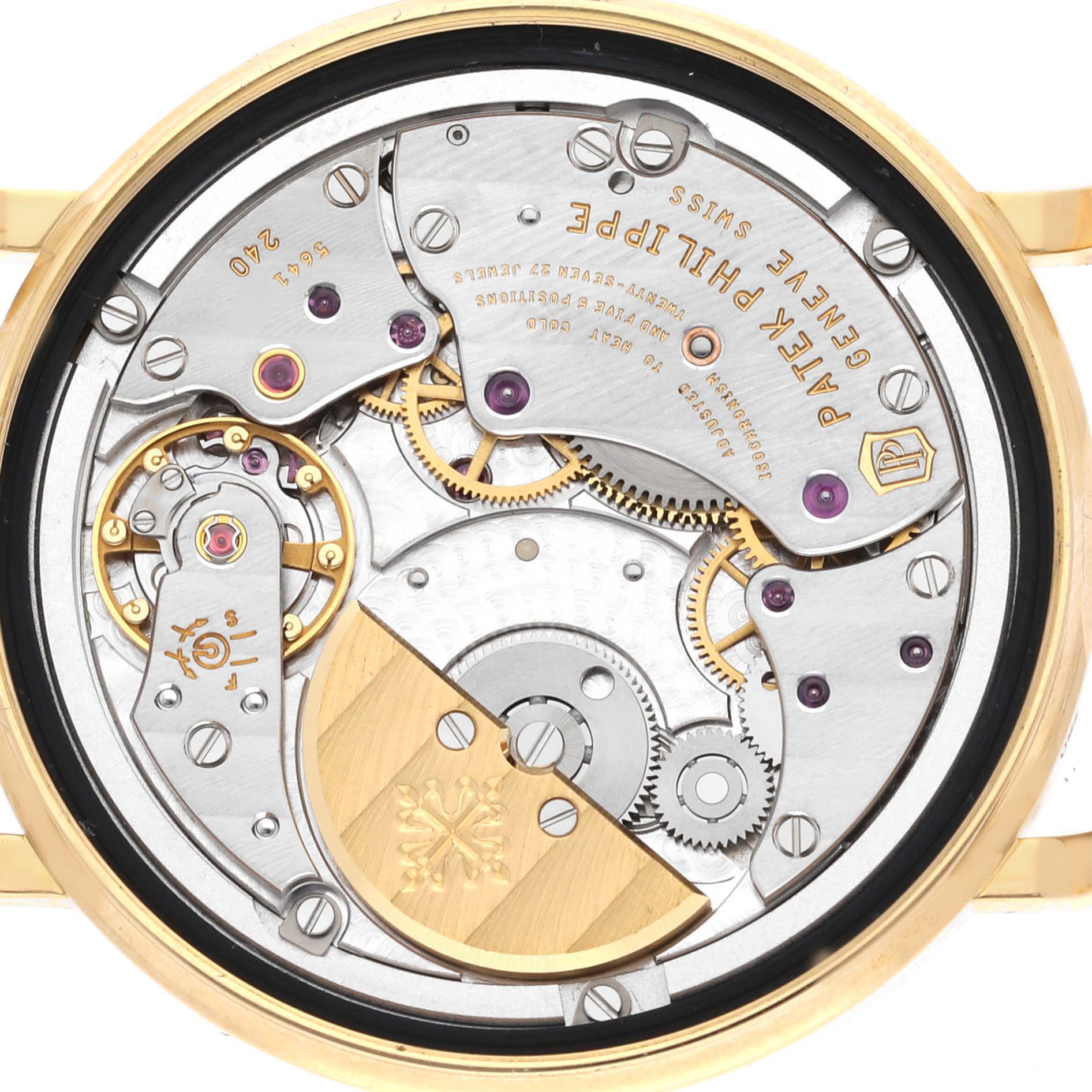 The image shows the movement and inner mechanics of a Patek Philippe Calatrava 5120J Men
s Yellow Gold White Dial 5120J Men
s Yellow Gold White Dial watch from a rear angle.