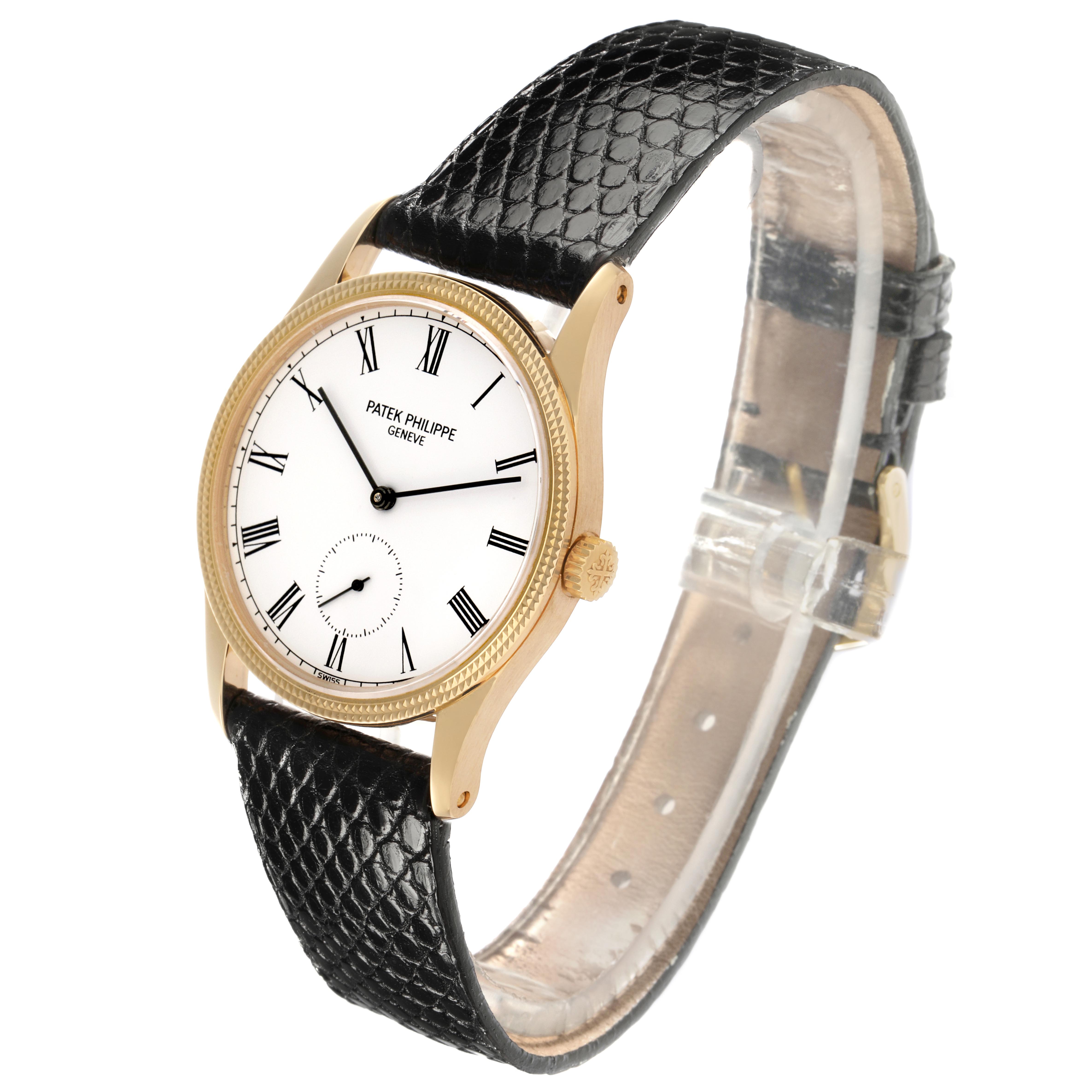 The Patek Philippe Calatrava 3796J Men
s Yellow Gold White Dial 3796J Men
s Yellow Gold White Dial watch is shown at an angled view, highlighting the face, crown, and leather strap.