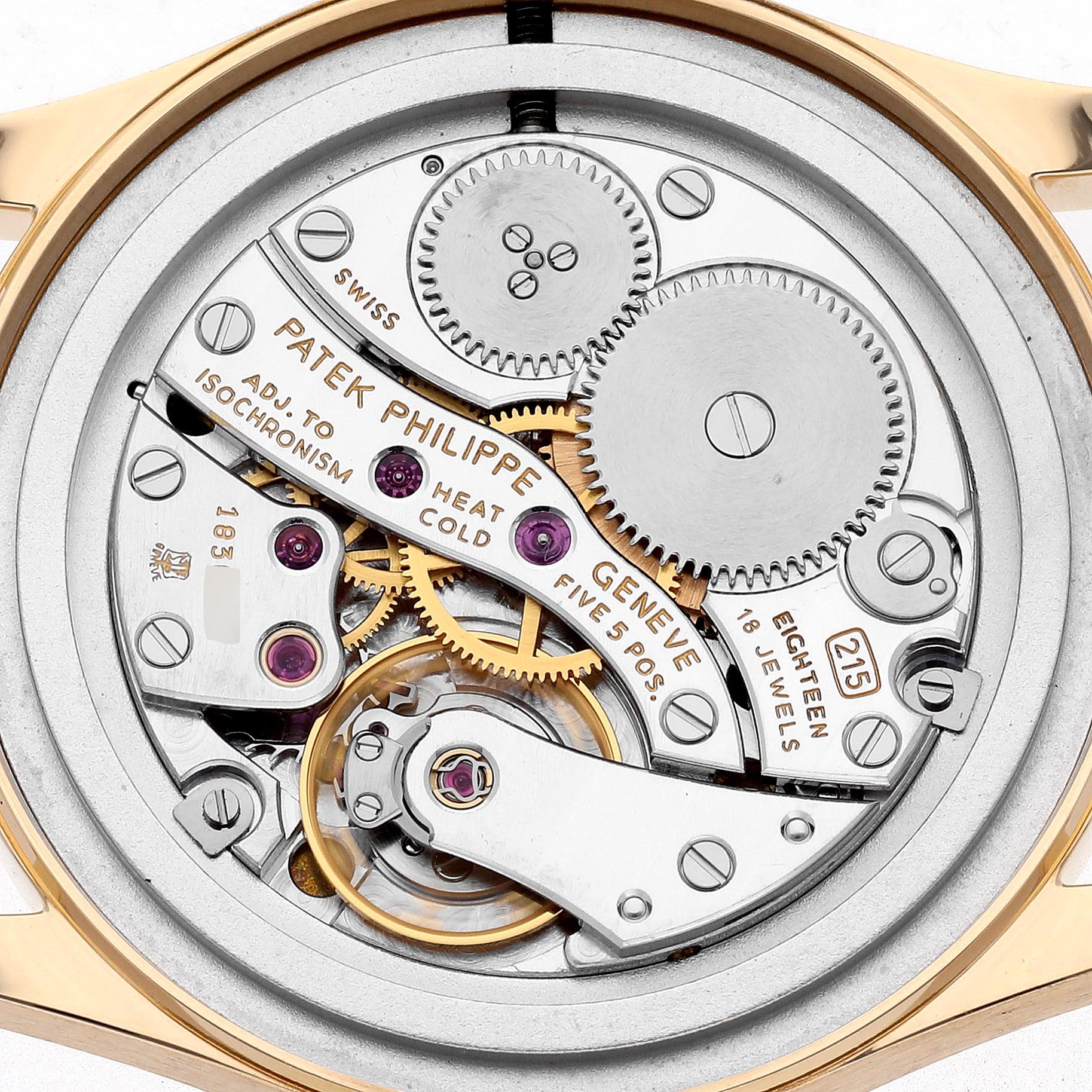 This image shows the movement of a Patek Philippe Calatrava 3796J Men
s Yellow Gold White Dial 3796J Men
s Yellow Gold White Dial watch from the back, highlighting its intricate gears and mechanisms.