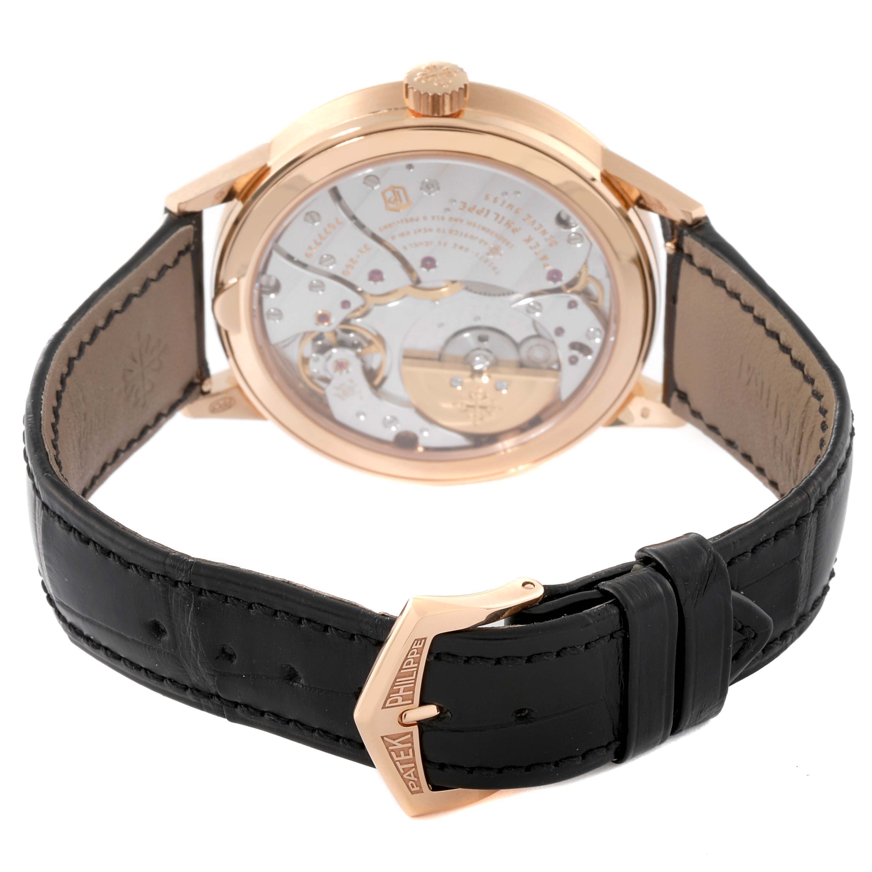 The image shows the back view of a Patek Philippe Complications 5235/50R-001 Men's Rose Gold Black Dial 5235/50R-001 Men's Rose Gold Black Dial watch, highlighting its movement and black leather strap.