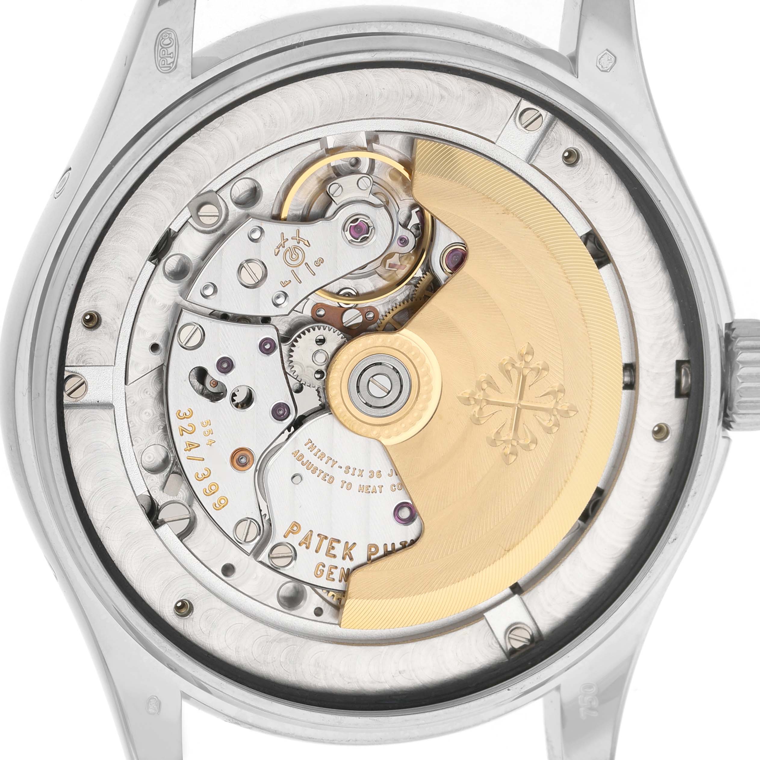 The image shows the back of a Patek Philippe Complications 5146G Men's White Gold White Dial watch, highlighting its intricate mechanical movement and rotor.