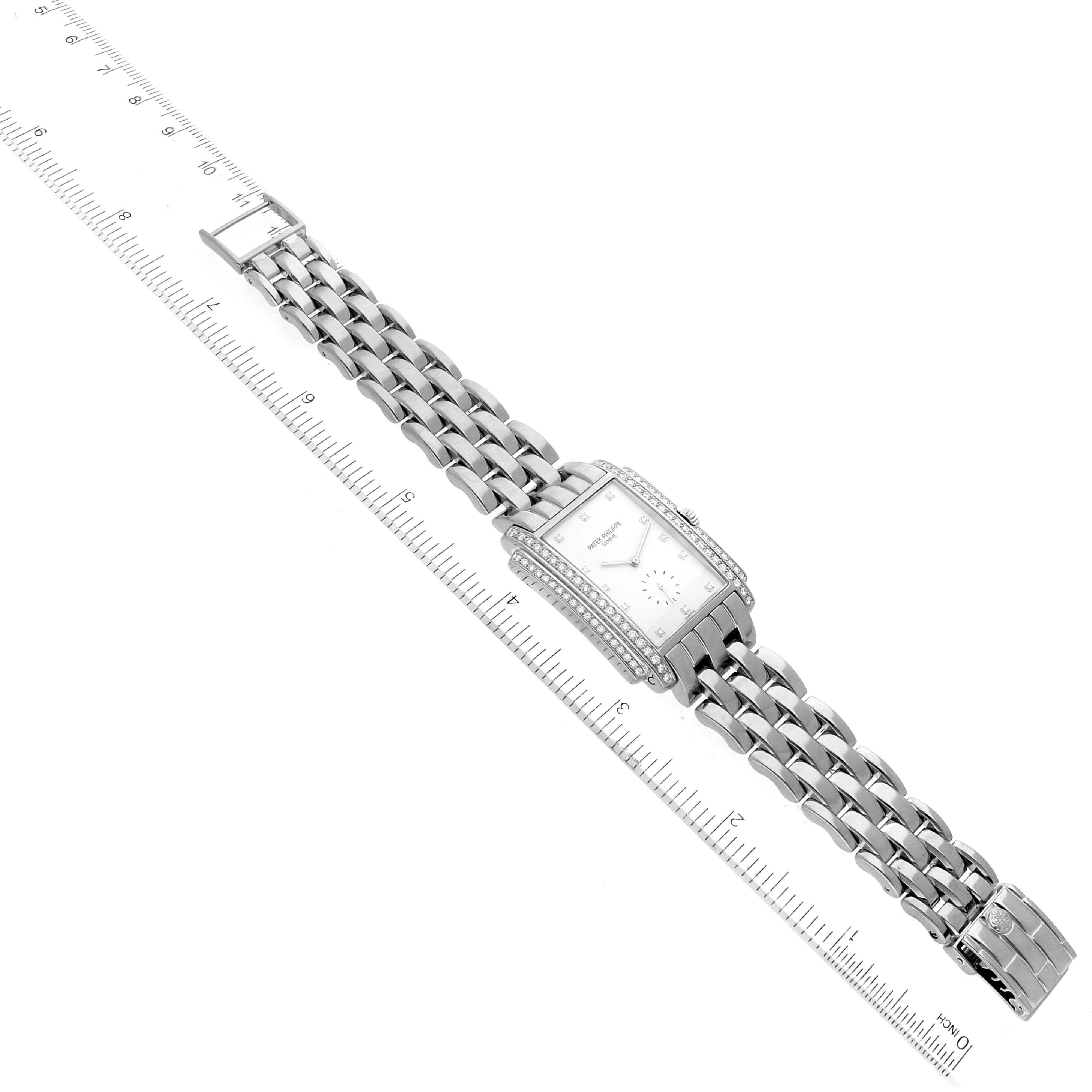 The image shows a top-down view of a Patek Philippe Gondolo 5025G Men's White Gold White Dial 5025G Men's White Gold White Dial watch with its full bracelet and clasp visible alongside a ruler.