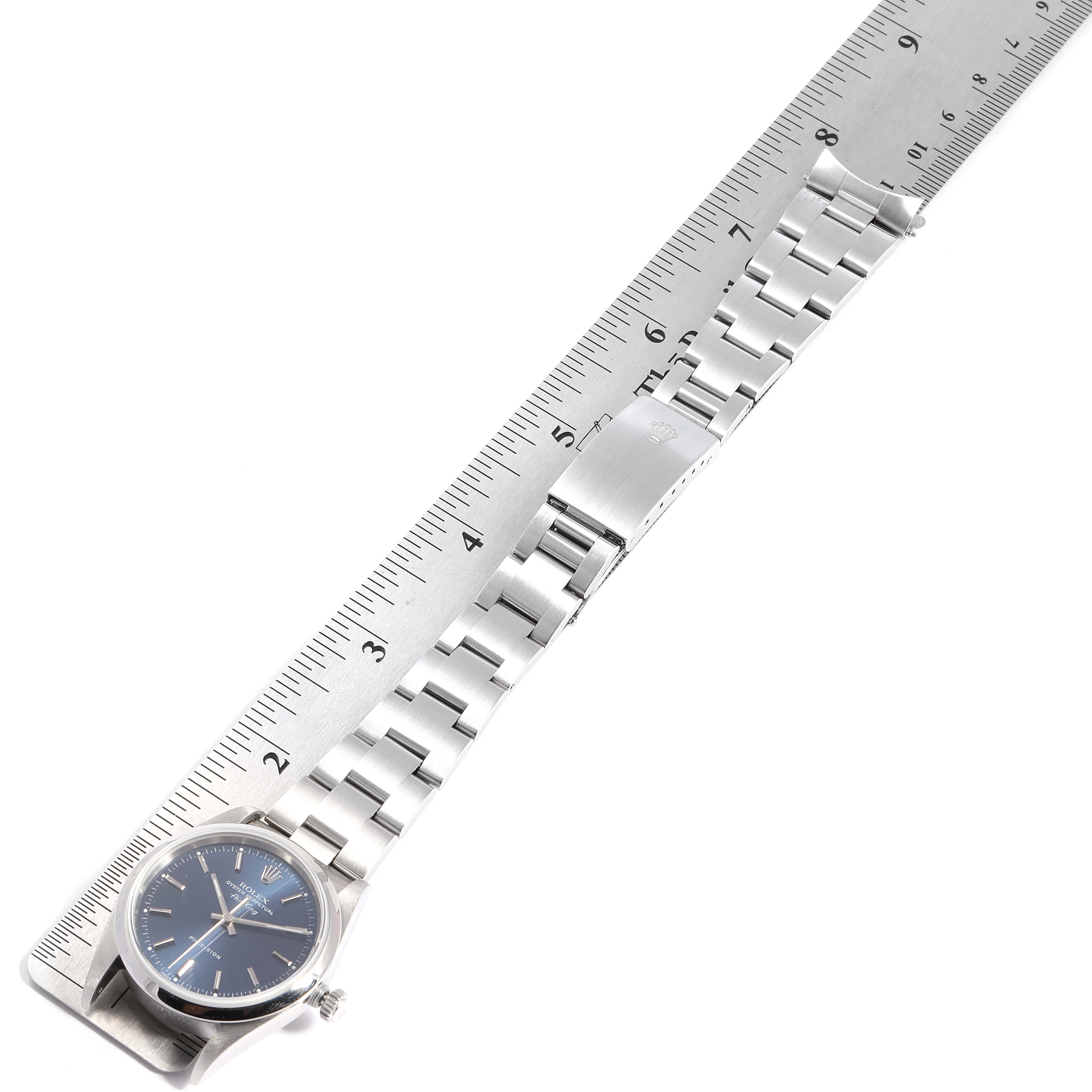 The Rolex Air-King 14000 Men's Stainless Steel Blue Dial 14000 Men's Stainless Steel Blue Dial watch is shown from the top, displaying the face, crown, and metal bracelet beside a ruler for measurement.