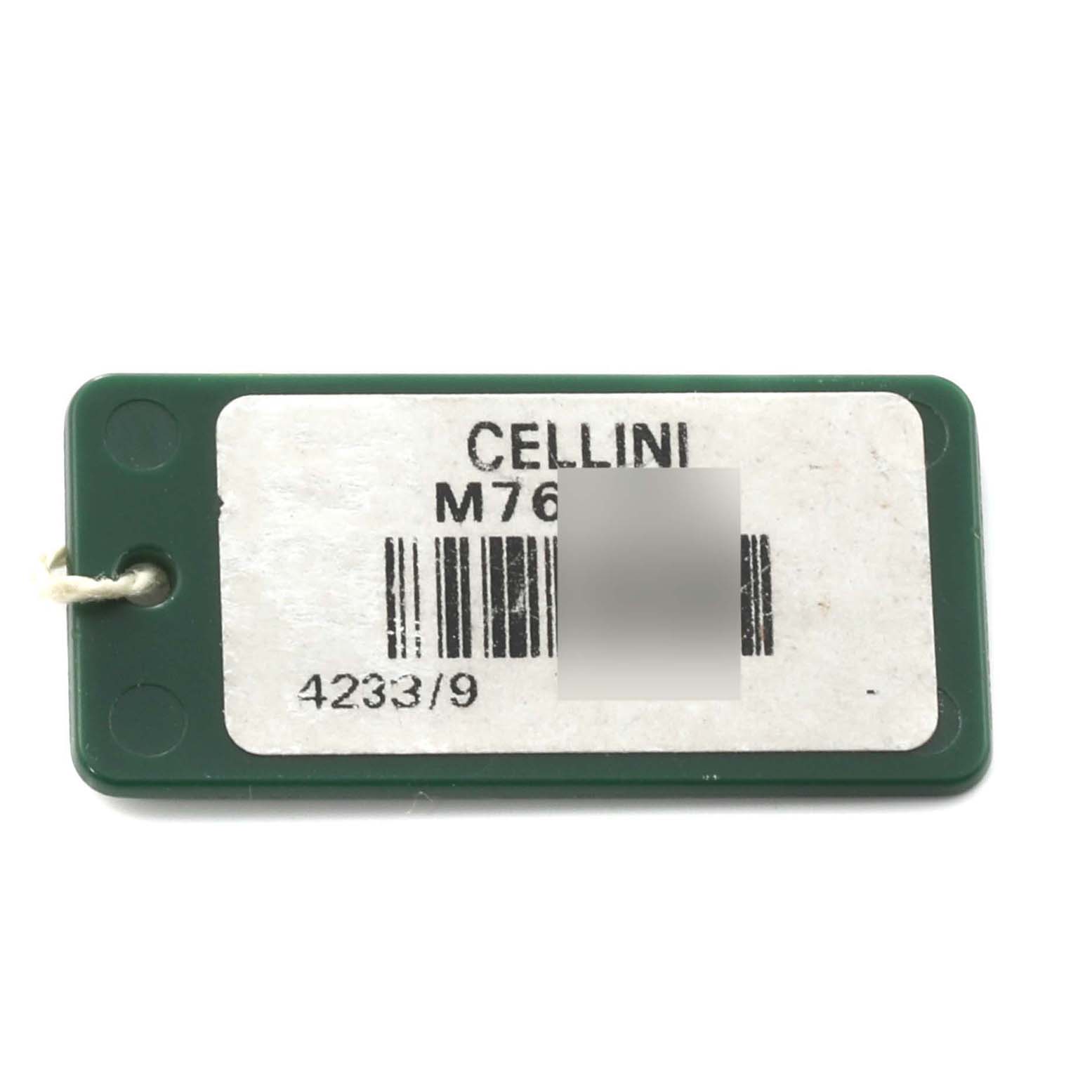 This image shows a close-up of a green and white tag labeled "Cellini" by Rolex with a barcode and model number.