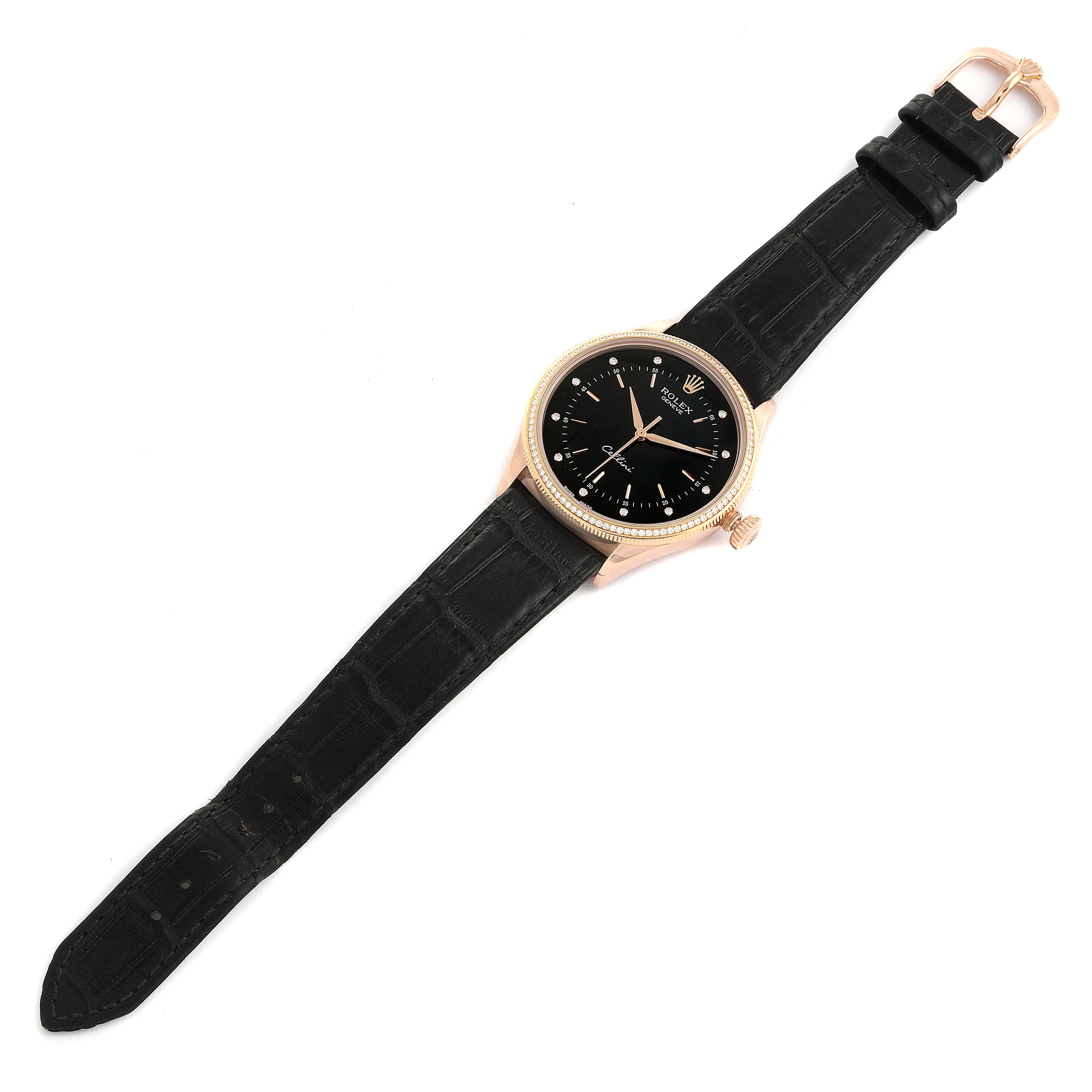 The image shows a top-down view of a Rolex Cellini 50605 Men
s Rose Gold Black Dial 50605 Men
s Rose Gold Black Dial watch, featuring a black strap and a black dial with gold accents.