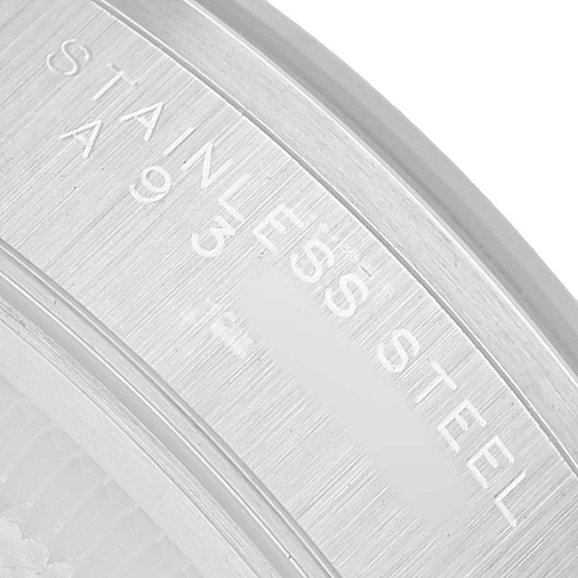The image shows a close-up of the engraving on the stainless steel case back of a Rolex Date 15200 Men's Stainless Steel Blue Dial watch.