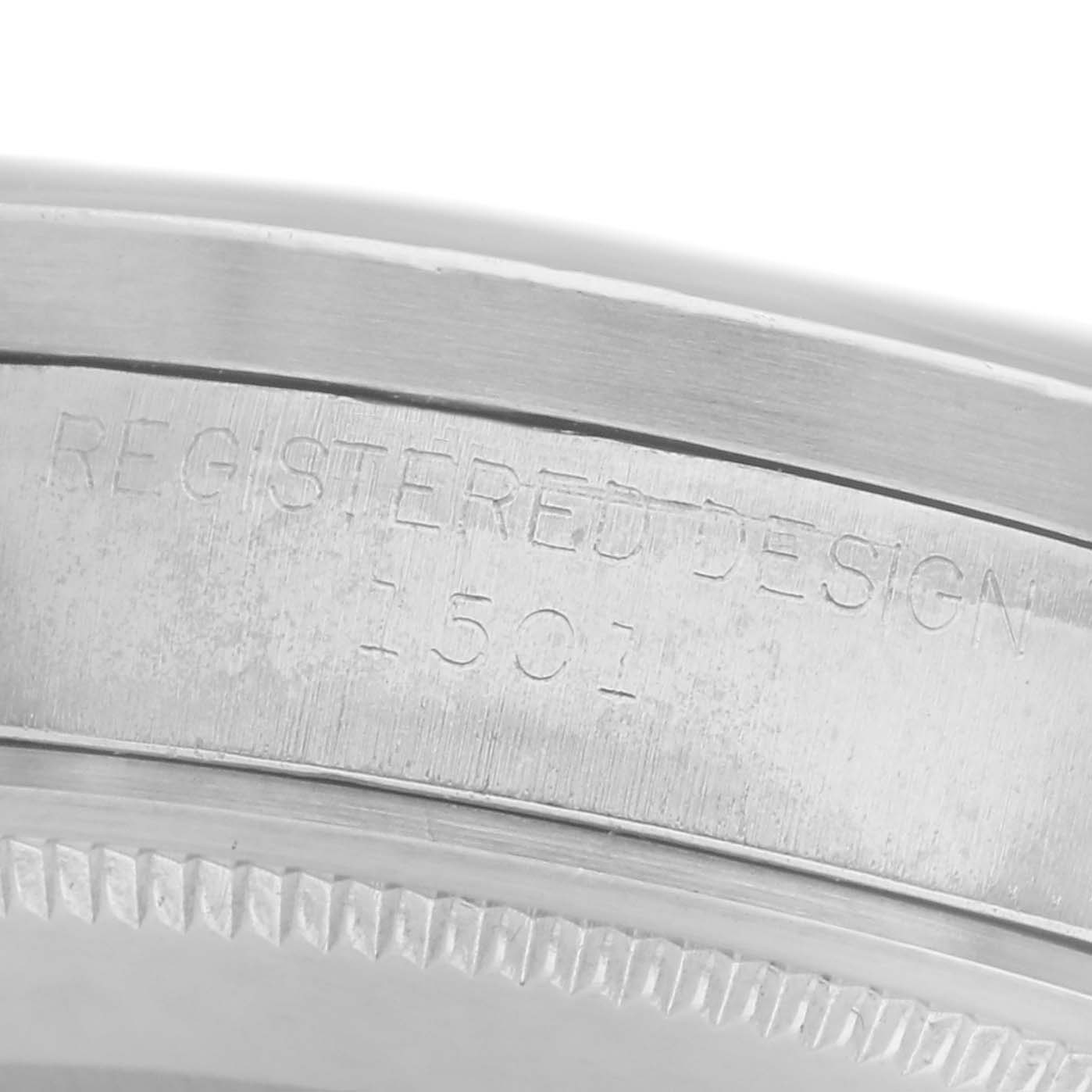 The image shows a close-up of the engraved case side of the Rolex Date model 1501.
