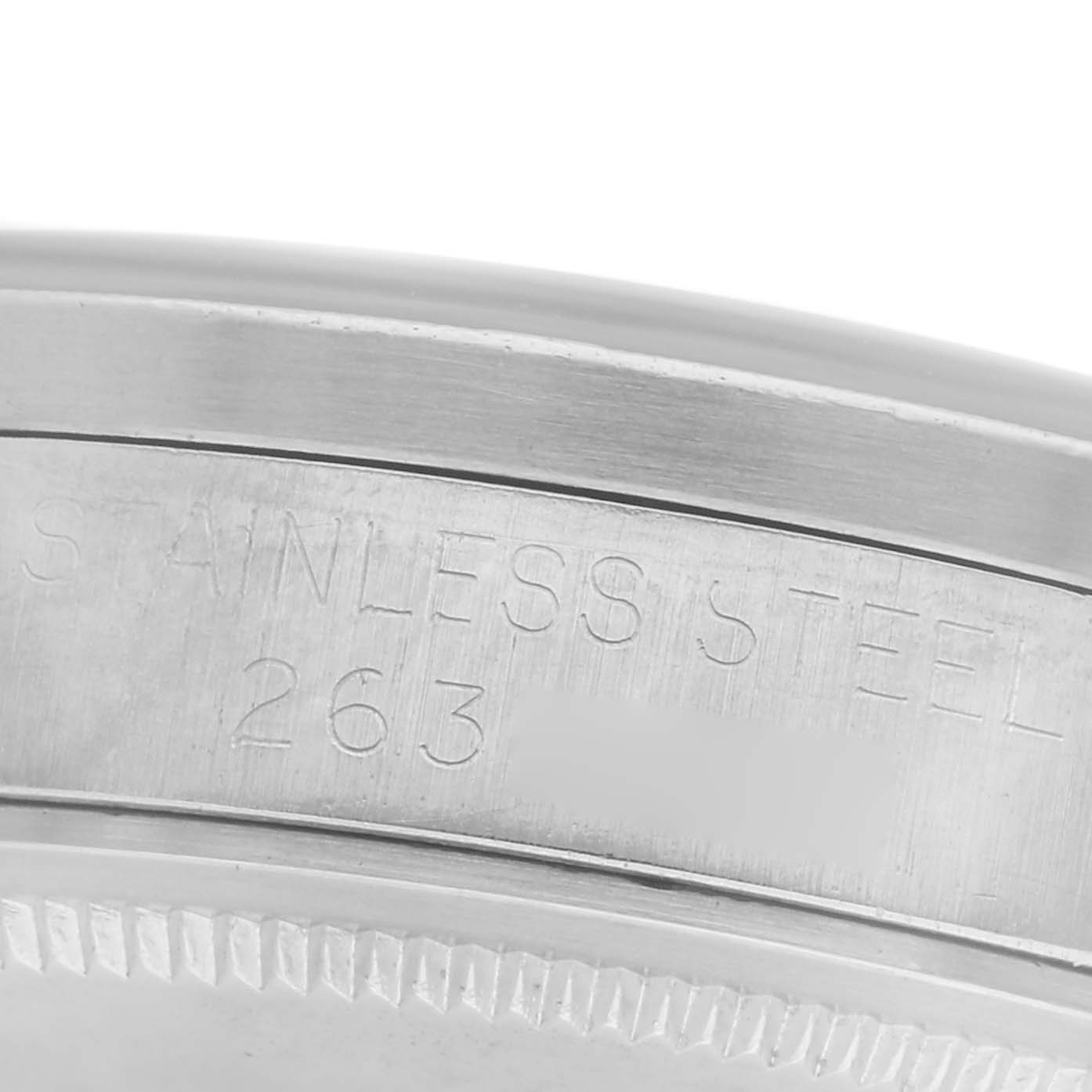 The image shows the engraved side of a Rolex Date model watch, highlighting "STAINLESS STEEL 263."