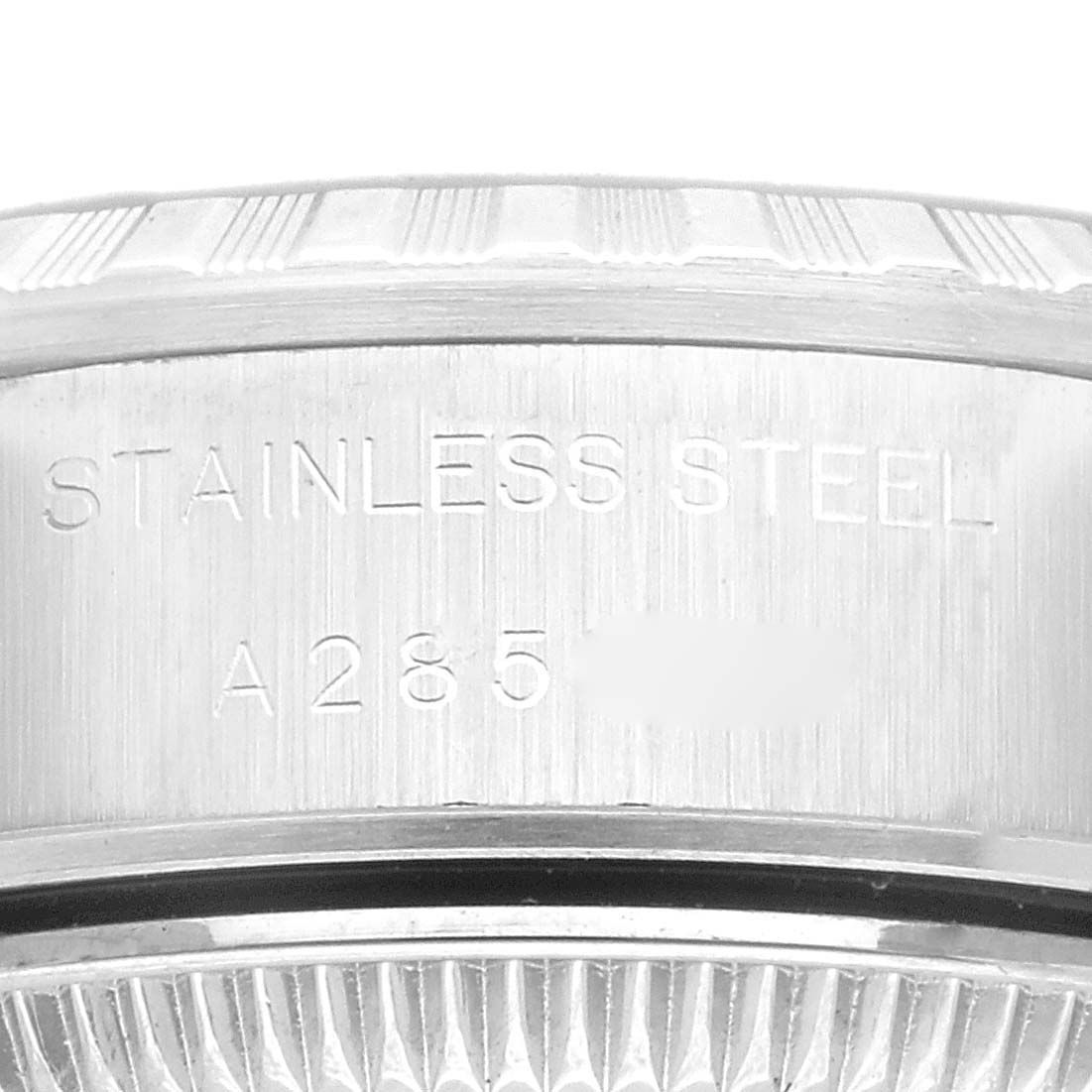 This is a close-up image of the case back and serial number of a Rolex Date 69240 Women's Stainless Steel Silver Dial 69240 Women's Stainless Steel Silver Dial model watch, focusing on the engraved text.