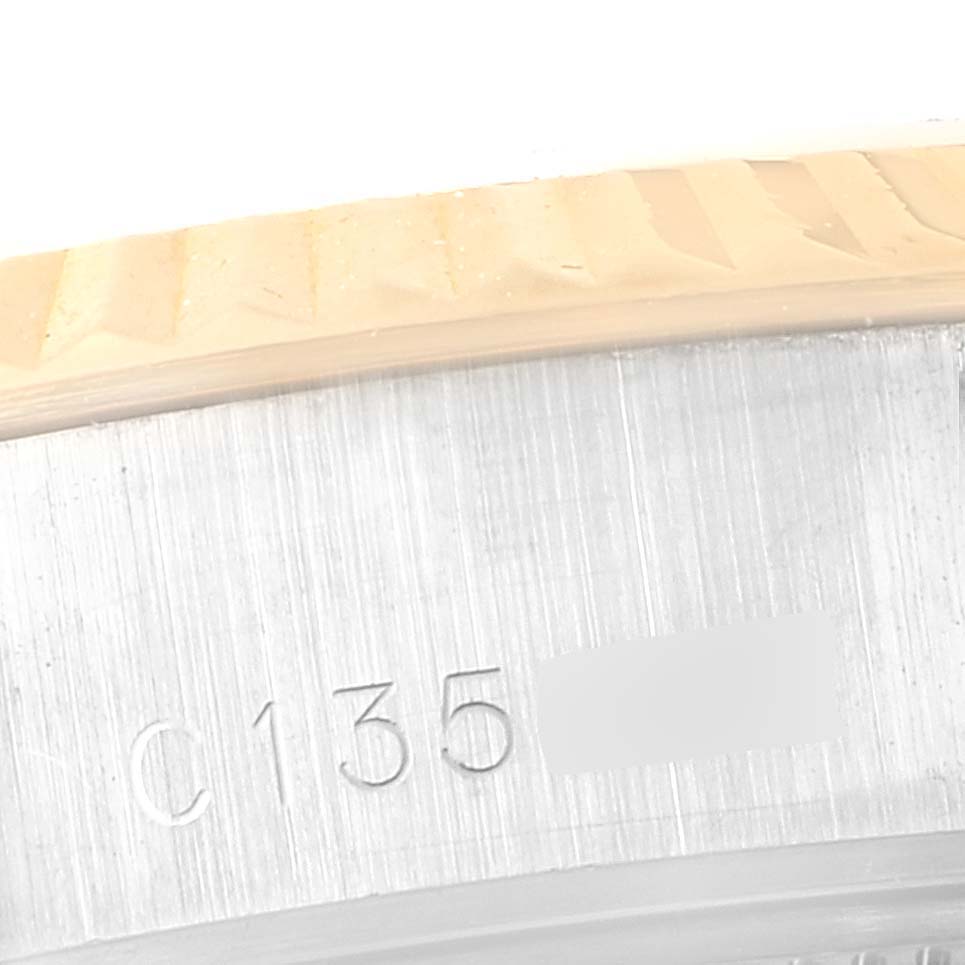 This image shows a close-up of the side of the Rolex Datejust 69173 Women's Steel and Gold (two tone) Champagne Dial 69173 Women's Steel and Gold (two tone) Champagne Dial model, detailing the fluted bezel and partial serial number.