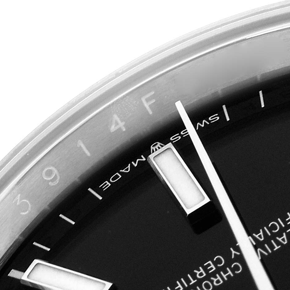The image shows a close-up of the dial and hour markers of a Rolex Datejust 126200 Men
s Stainless Steel Black Dial 126200 Men
s Stainless Steel Black Dial.