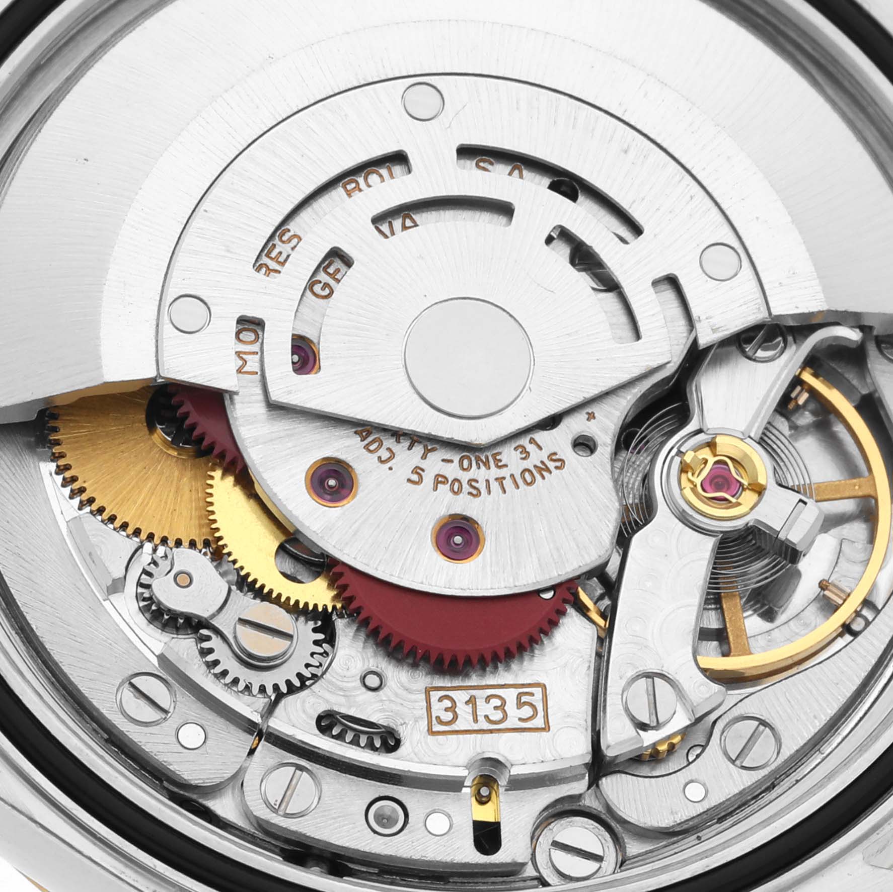 This image shows a close-up view of the movement mechanism inside a Rolex Datejust 16233 Men's Steel and Gold (two tone) White Dial 16233 Men's Steel and Gold (two tone) White Dial watch, including gears, screws, and the balance wheel.