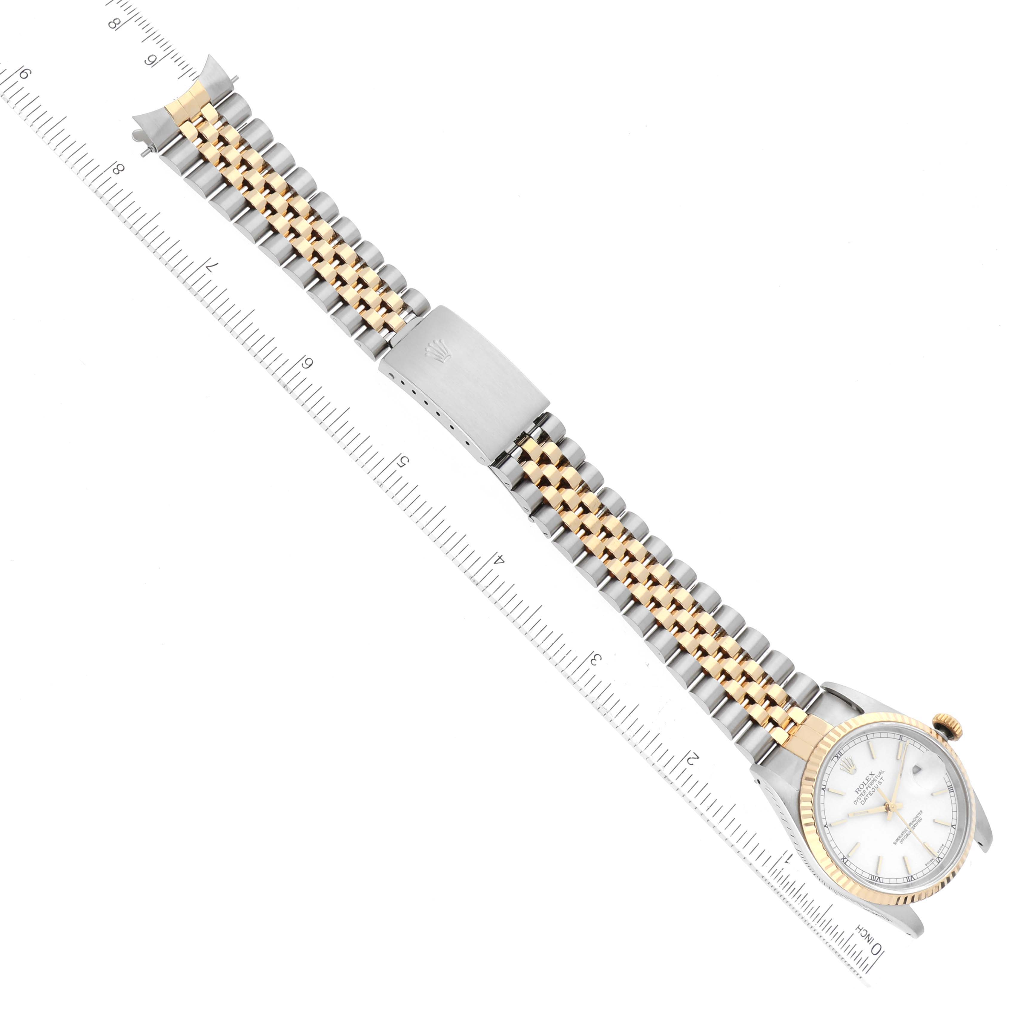 This image shows the full bracelet and face of a Rolex Datejust 16233 Men's Steel and Gold (two tone) White Dial 16233 Men's Steel and Gold (two tone) White Dial watch, with a clasp and ruler for scale.