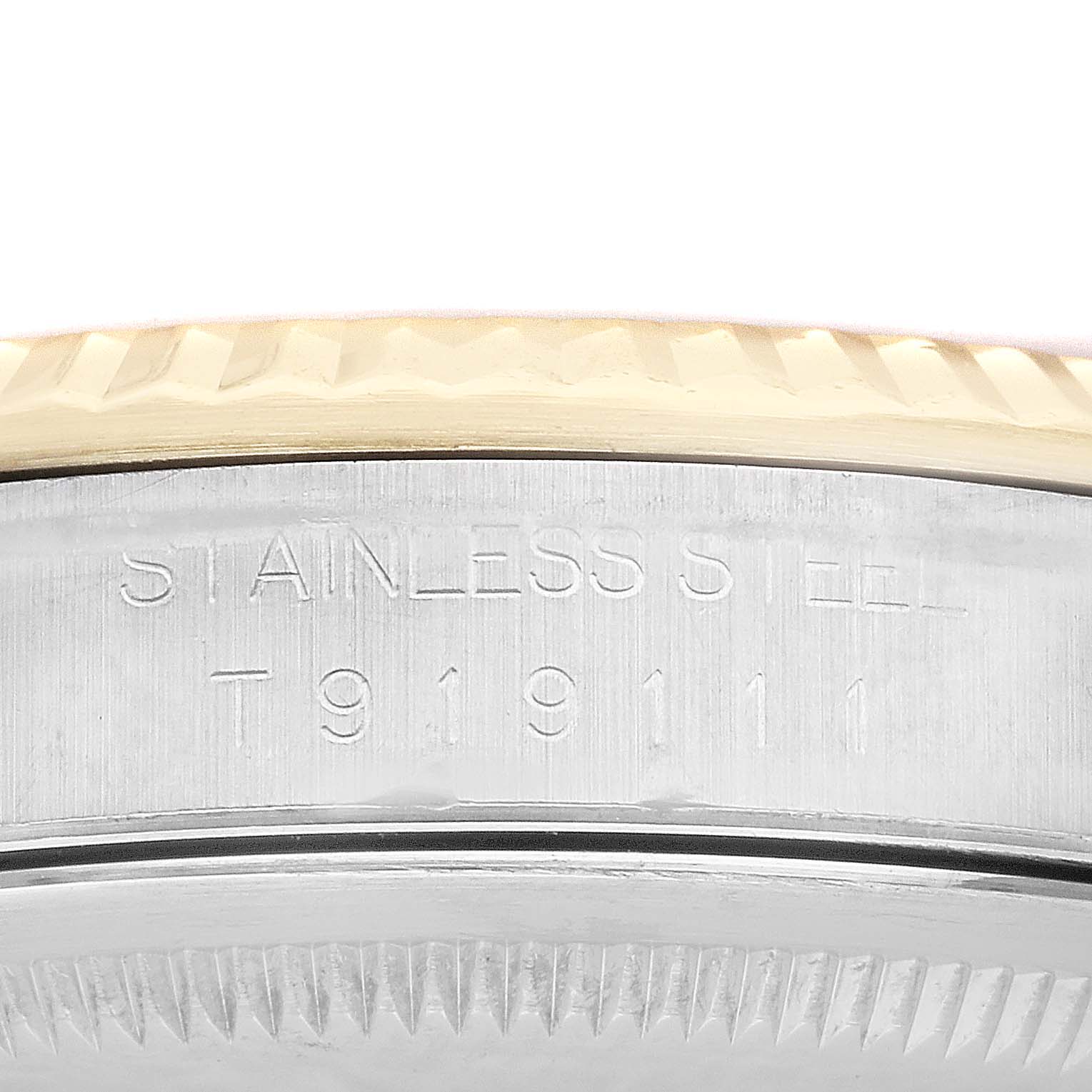 This image shows a close-up of the side of a Rolex Datejust 16233 Men's Steel and Gold (two tone) Champagne Dial 16233 Men's Steel and Gold (two tone) Champagne Dial watch, highlighting the engraving and the fluted bezel.