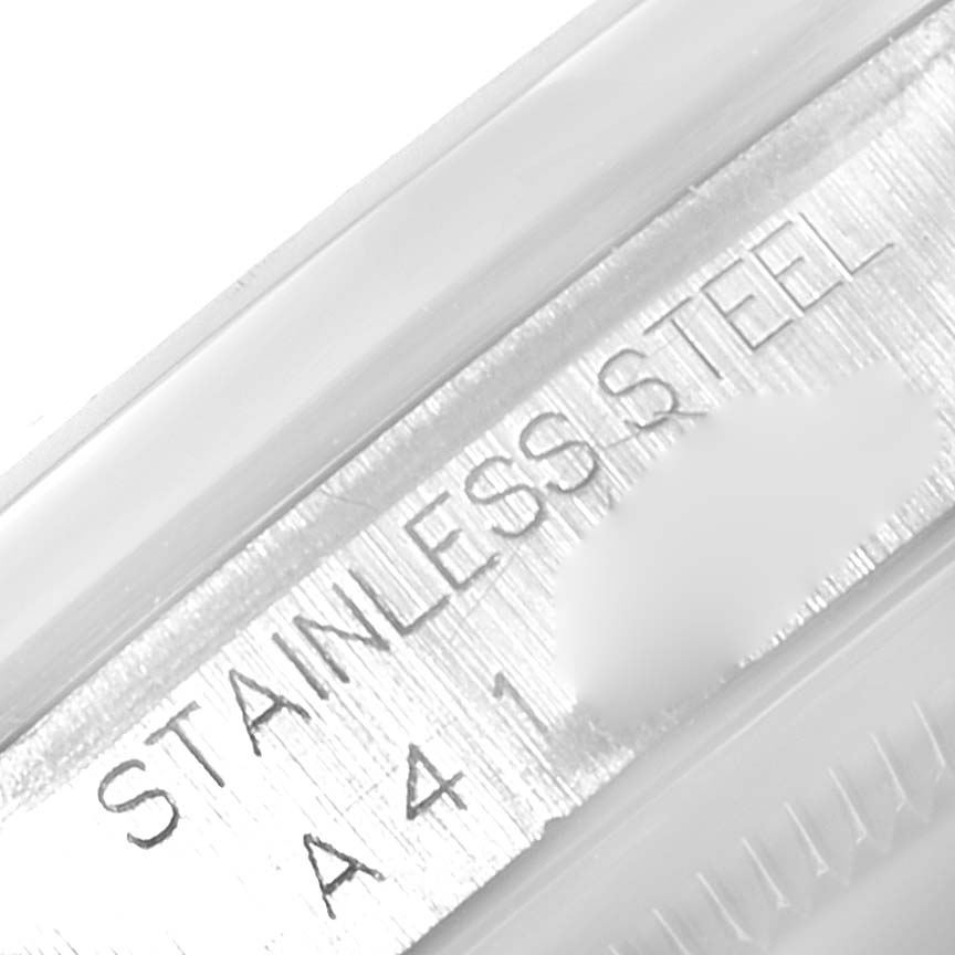 The image shows a close-up of the stainless steel part of a Rolex Datejust 16200 Men's Stainless Steel Blue Dial 16200 Men's Stainless Steel Blue Dial watch, featuring engraved text.