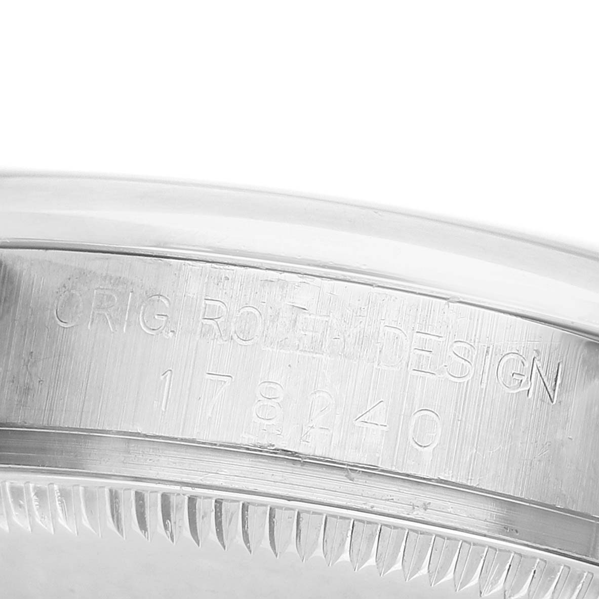 The image shows the edge and engraved serial number on the case side of a Rolex Datejust 178240 Women's Stainless Steel Silver Dial watch.