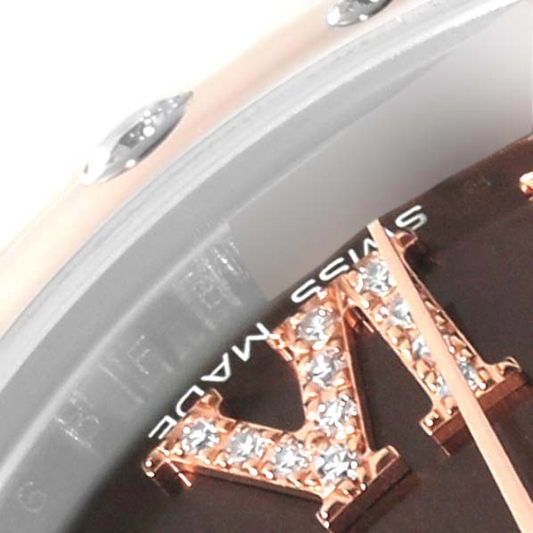 This close-up image of a Mid-Size Rolex watch shows part of a jewel-encrusted Roman numeral and the bezel.