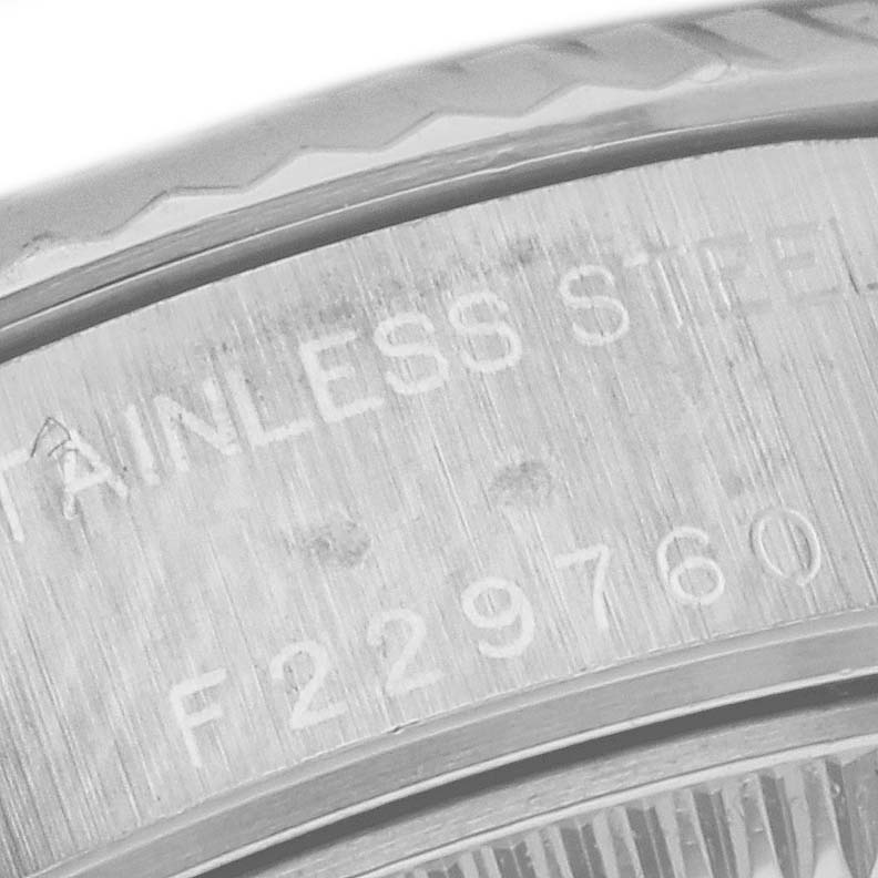 The image shows a close-up of the serial number and part of the bezel and case back of a Rolex Datejust 79174 Women's Stainless Steel White Dial 79174 Women's Stainless Steel White Dial watch.