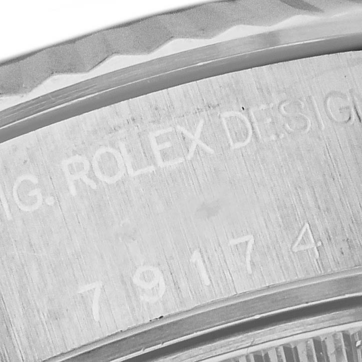This image shows a close-up of the engraved inner bezel and serial number of a Rolex Datejust 79174 Women's Stainless Steel White Dial 79174 Women's Stainless Steel White Dial watch.