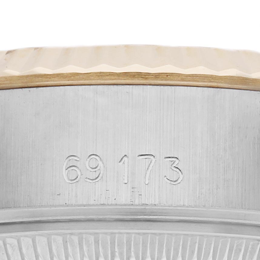 The image shows a close-up of the model number engraving on the side of a Rolex Datejust 69173 Women
s Steel and Gold (two tone) Champagne Dial 69173 Women
s Steel and Gold (two tone) Champagne Dial watch
s stainless steel case.