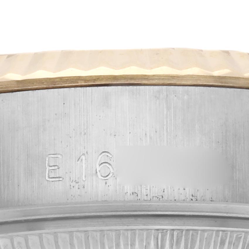 The image shows a close-up of the case side of a Rolex Datejust 69173 Women
s Steel and Gold (two tone) Champagne Dial 69173 Women
s Steel and Gold (two tone) Champagne Dial, highlighting the engraved serial number and fluted bezel edge.