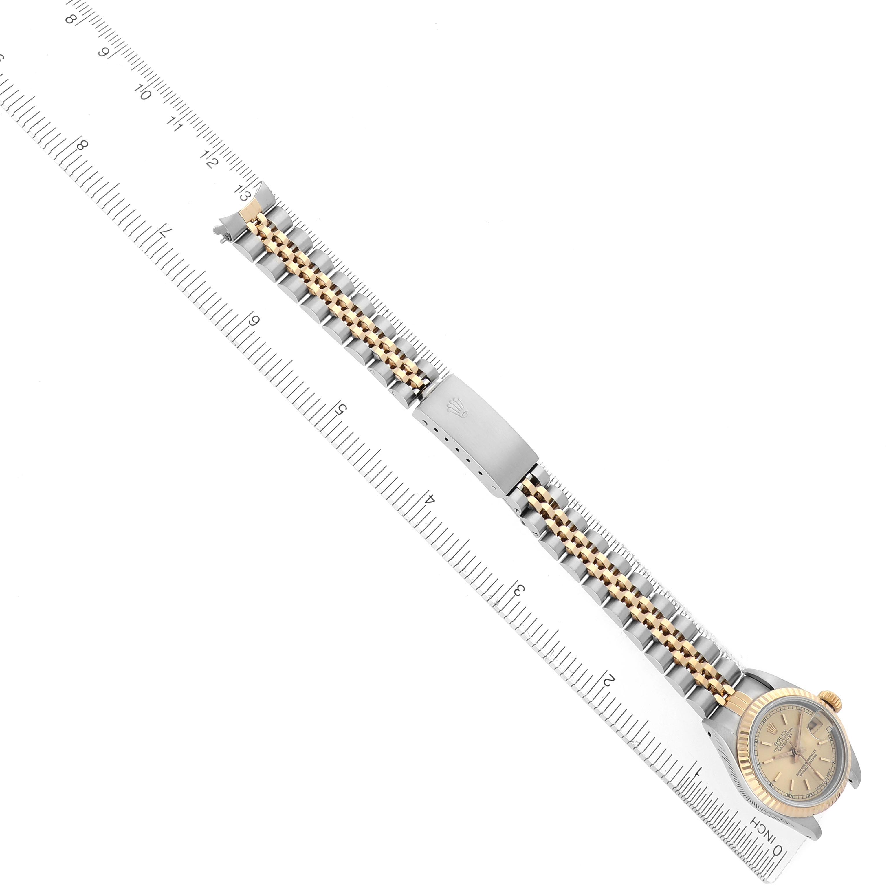 The Rolex Datejust 69173 Women
s Steel and Gold (two tone) Champagne Dial 69173 Women
s Steel and Gold (two tone) Champagne Dial watch is shown from an overhead angle, displaying the entire bracelet, clasp, and face.