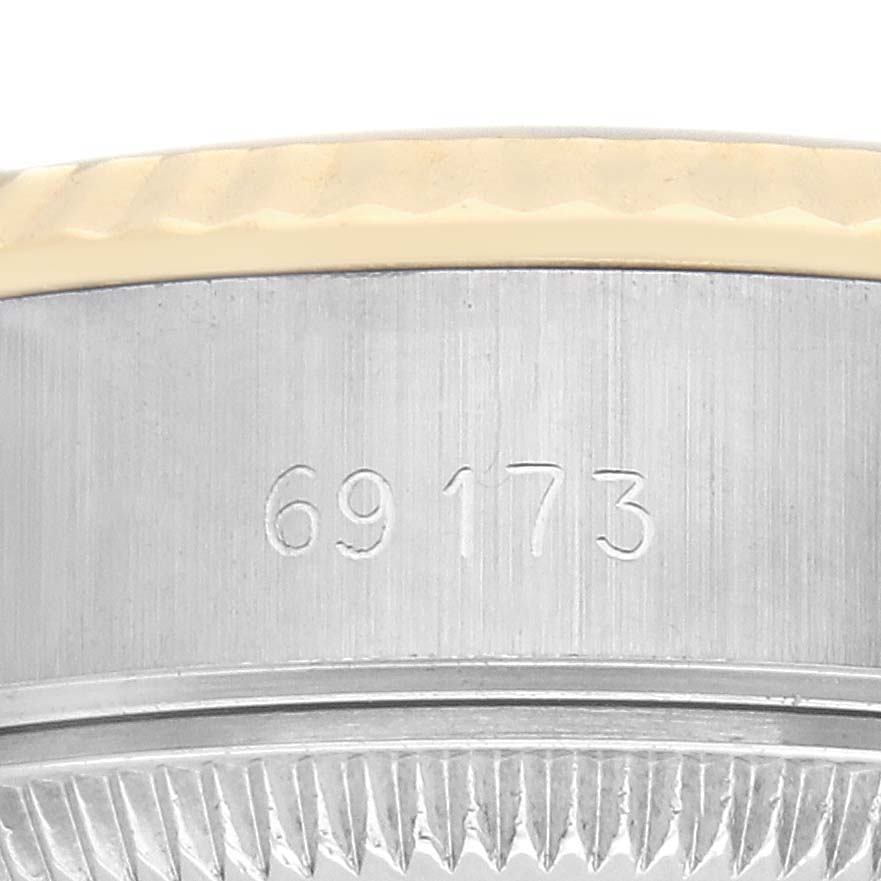 The image shows a close-up side view of the Rolex Datejust 69173 Women
s Steel and Gold (two tone) Champagne Dial 69173 Women
s Steel and Gold (two tone) Champagne Dial model
s bezel and case, highlighting the model number engraving.
