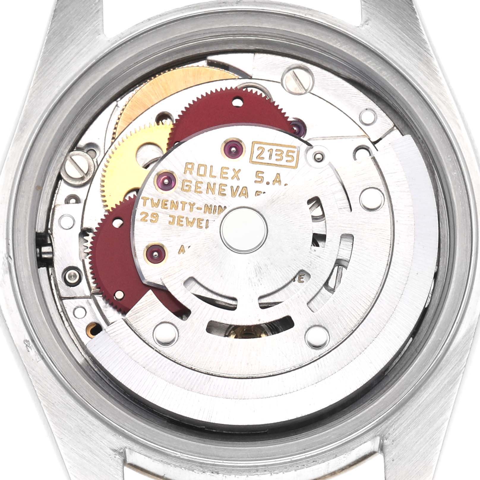 The image shows the movement of a Rolex Datejust 69173 Women
s Steel and Gold (two tone) Champagne Dial 69173 Women
s Steel and Gold (two tone) Champagne Dial, highlighting gears and the rotor from the back.