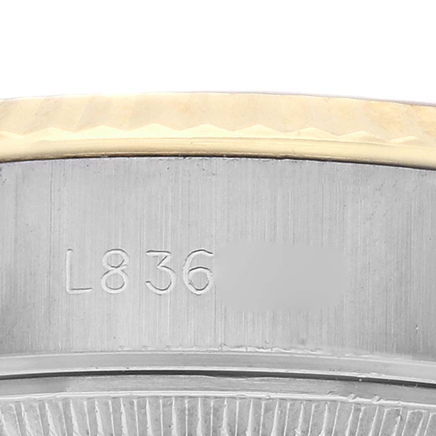 The image shows a close-up of the side of a Rolex Datejust 69173 Women
s Steel and Gold (two tone) Champagne Dial 69173 Women
s Steel and Gold (two tone) Champagne Dial, focusing on the bezel and engraved details.