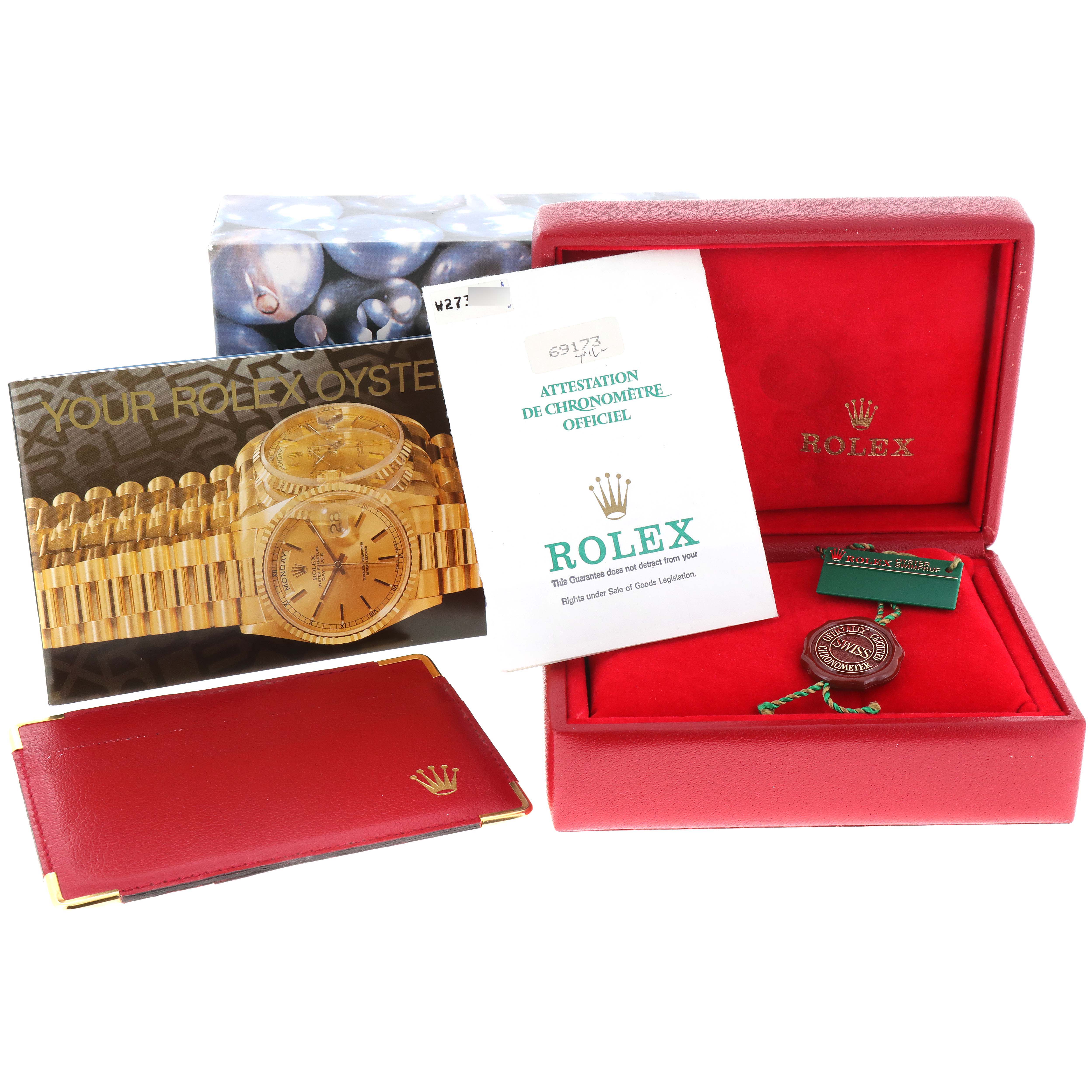 The image shows the accessories of a Rolex Datejust 69173 Women's Steel and Gold (two tone) Blue Dial 69173 Women's Steel and Gold (two tone) Blue Dial, including the box, warranty card, booklet, and tag.