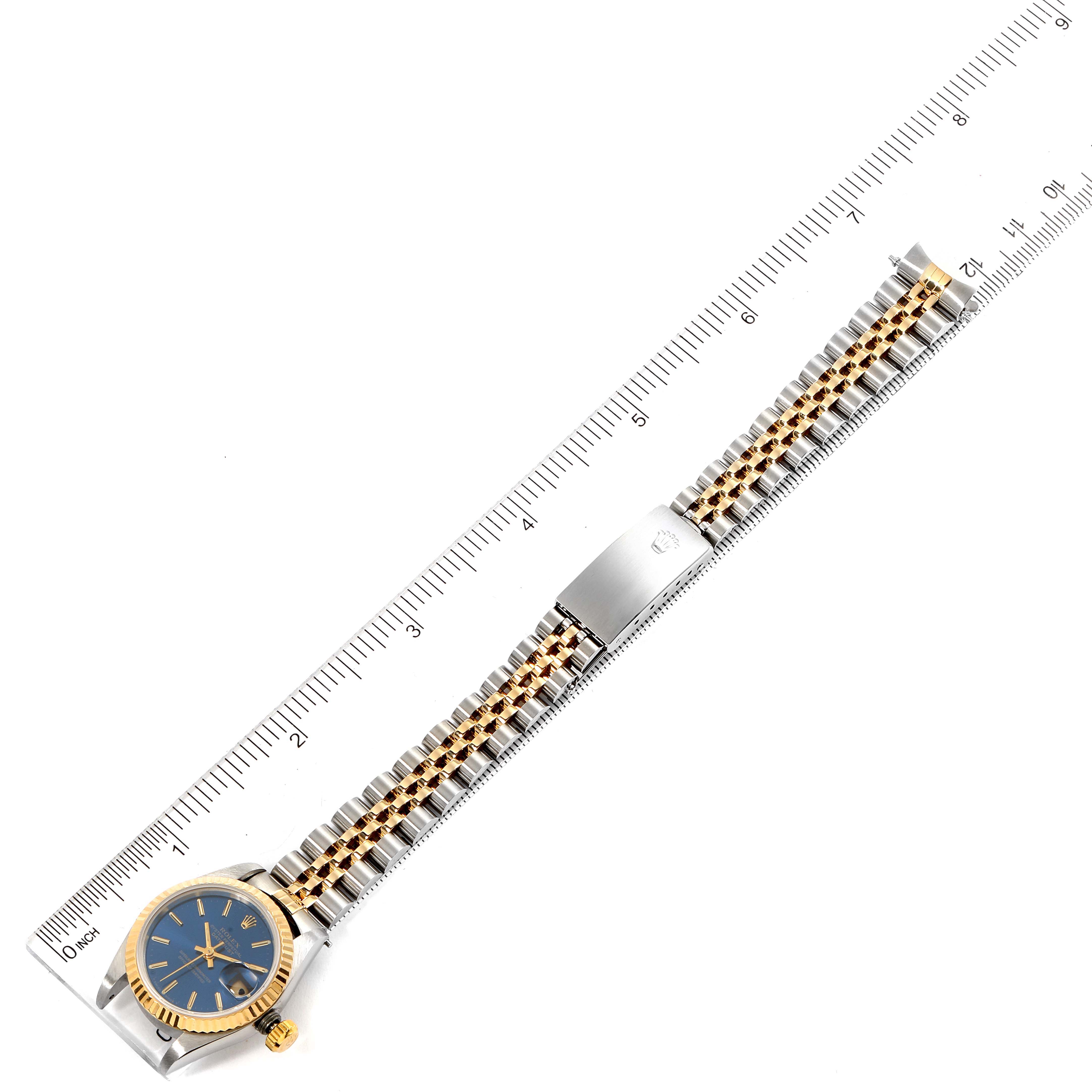 The image shows a Rolex Datejust 69173 Women's Steel and Gold (two tone) Blue Dial 69173 Women's Steel and Gold (two tone) Blue Dial watch laid flat with its bracelet and clasp visible, alongside a measuring ruler.