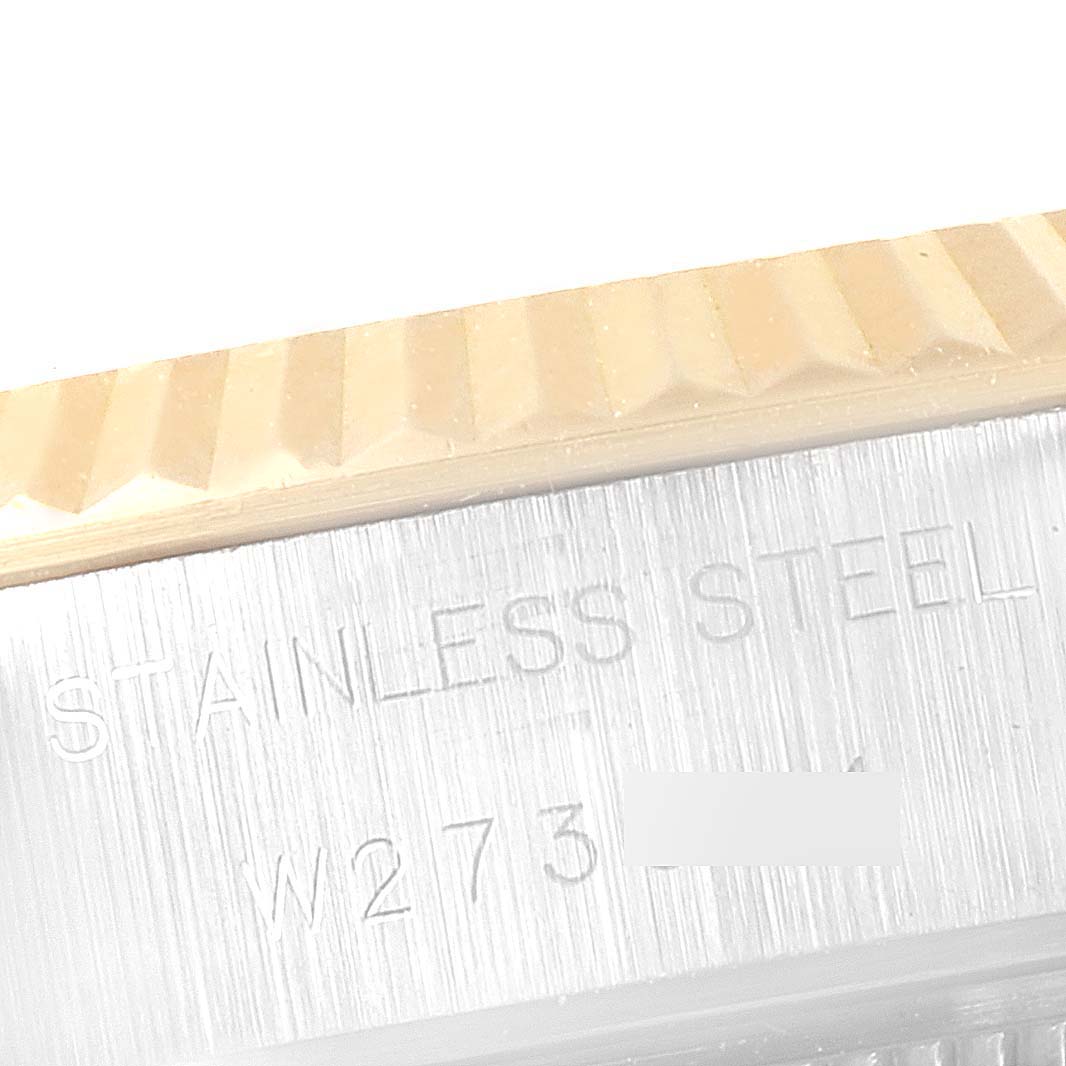 This image shows a close-up view of the fluted bezel and case side, featuring the engraving on the Rolex Datejust 69173 Women's Steel and Gold (two tone) Blue Dial 69173 Women's Steel and Gold (two tone) Blue Dial.