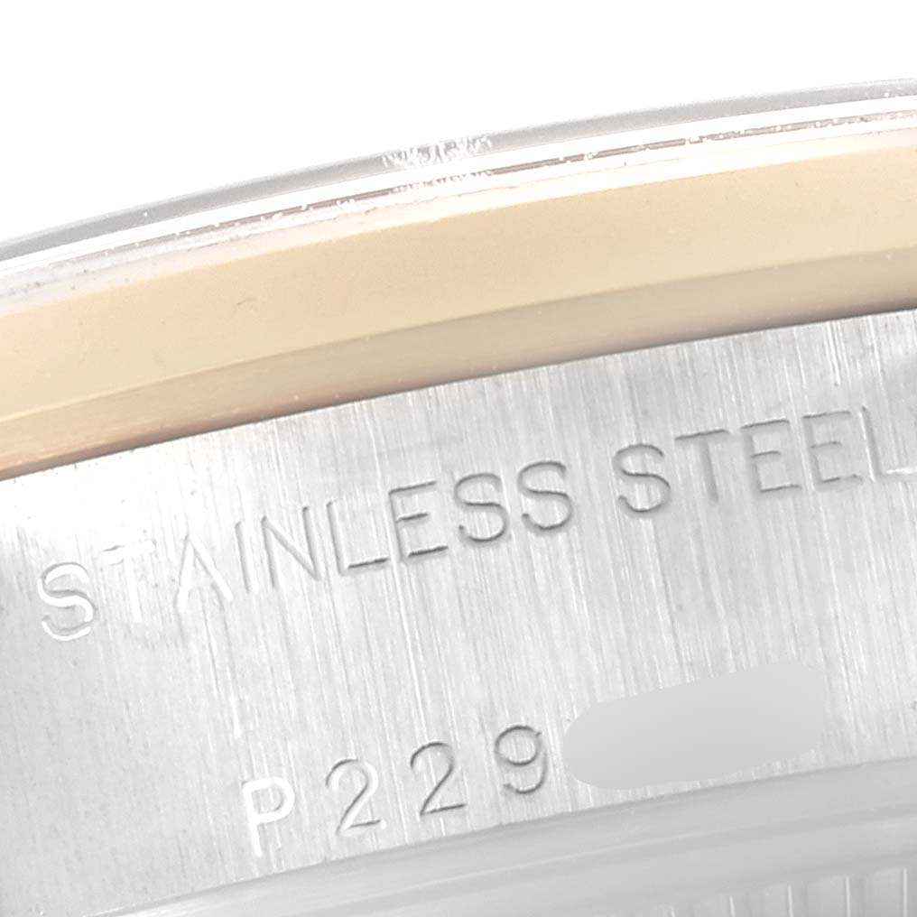 This image shows a close-up of the case back of a Rolex Datejust 79163 Women's Steel and Gold (two tone) Mother of Pearl Dial 79163 Women's Steel and Gold (two tone) Mother of Pearl Dial watch, highlighting the "STAINLESS STEEL" engraving and part of the serial number.