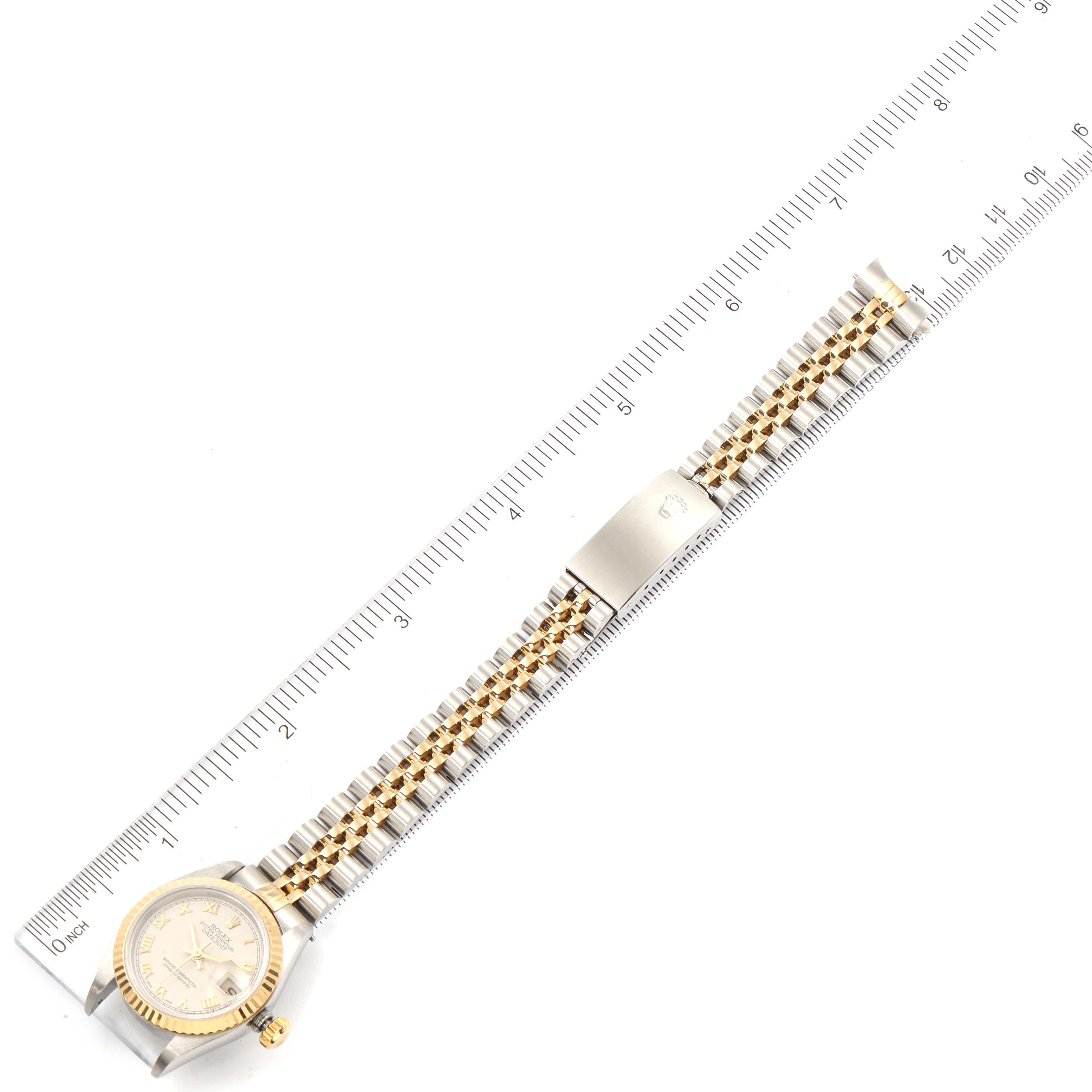 The image shows a Rolex Datejust 79173 Women
s Steel and Gold (two tone) Beige Dial 79173 Women
s Steel and Gold (two tone) Beige Dial watch laid flat with a ruler measuring its length.