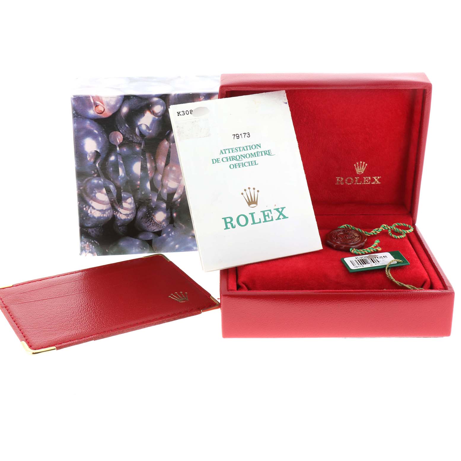 The image shows the packaging and accessories of a Rolex Datejust 79173 Women
s Steel and Gold (two tone) Beige Dial 79173 Women
s Steel and Gold (two tone) Beige Dial, including a red box, booklet, and tags, viewed from the front.