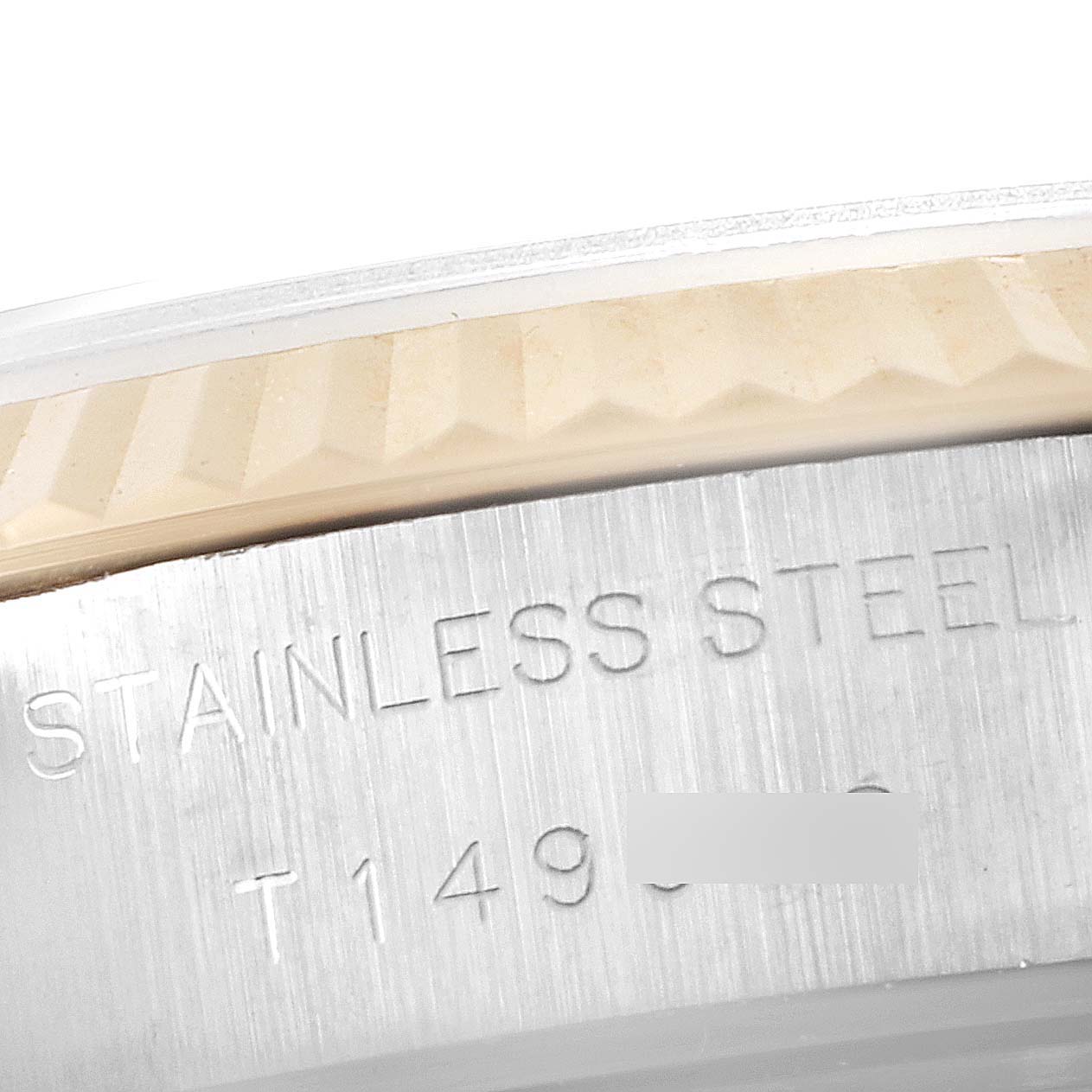 This is a close-up of the side engraving and part of the bezel of a Rolex Datejust 69173 Women's Steel and Gold (two tone) Silver Dial 69173 Women's Steel and Gold (two tone) Silver Dial watch, focusing on the stainless steel text.