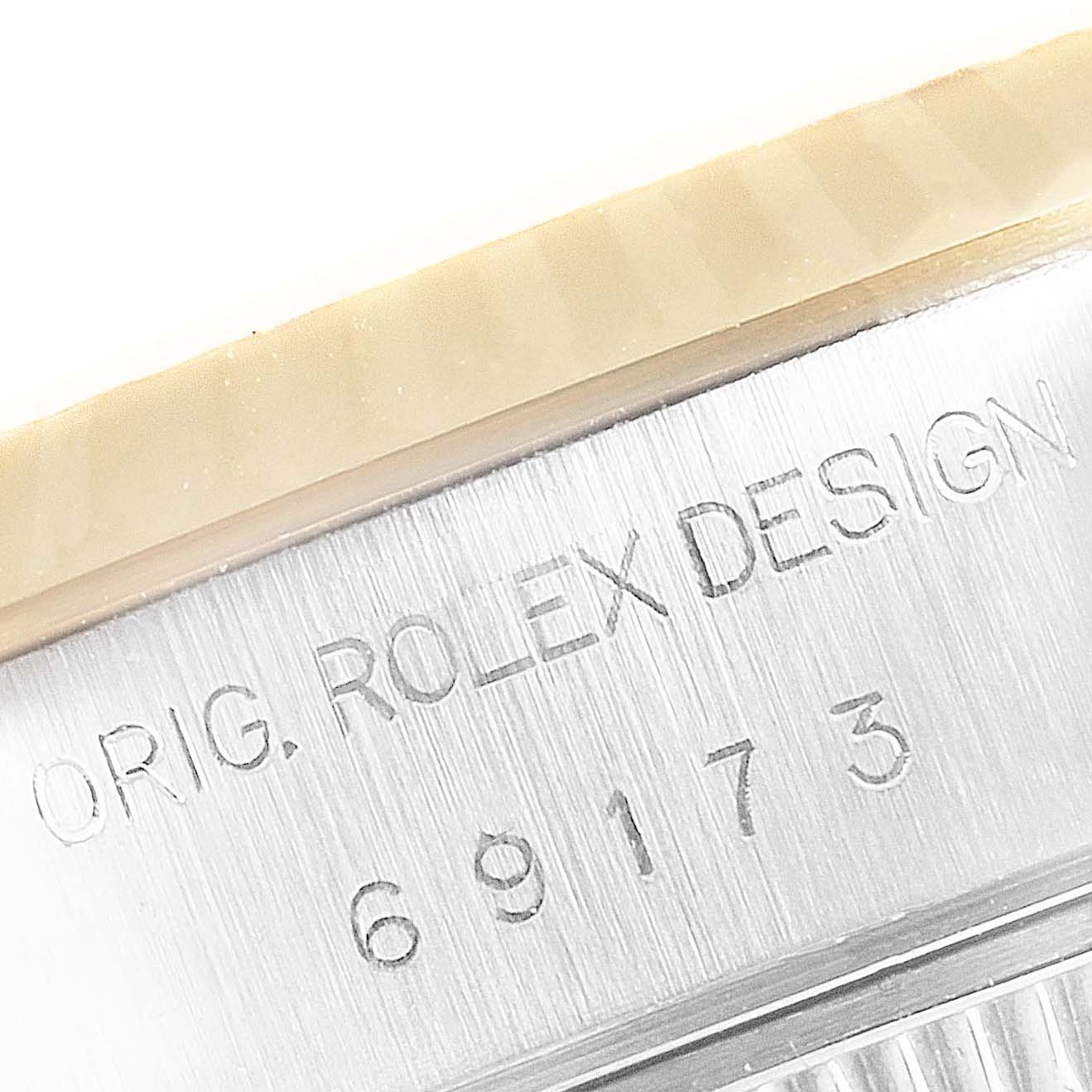 This image shows a close-up of the model number "69173" and "ORIG. ROLEX DESIGN" engraving on the side of a Rolex Datejust 69173 Women's Steel and Gold (two tone) Silver Dial 69173 Women's Steel and Gold (two tone) Silver Dial watch.