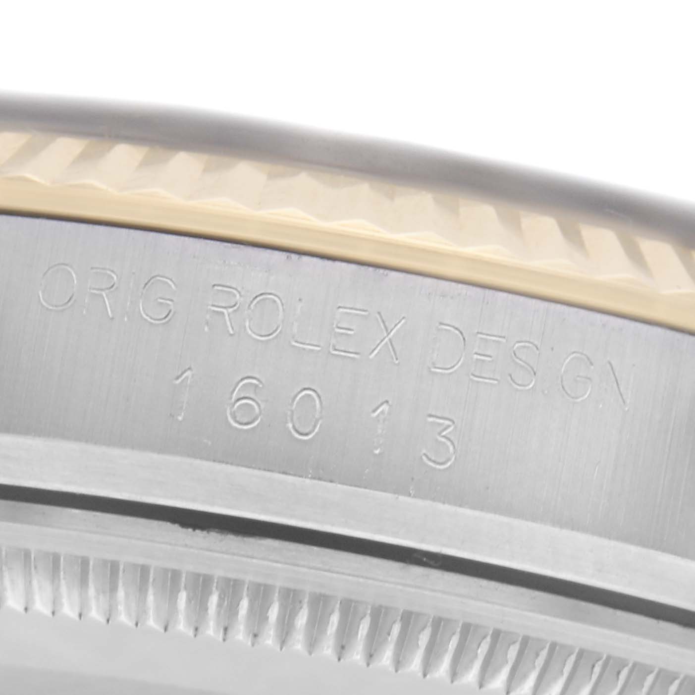 The image shows a close-up of the case side of a Rolex Datejust 16013 Men
s Steel and Gold (two tone) Champagne Dial 16013 Men
s Steel and Gold (two tone) Champagne Dial, highlighting the engraved model number "16013" and part of the bezel.