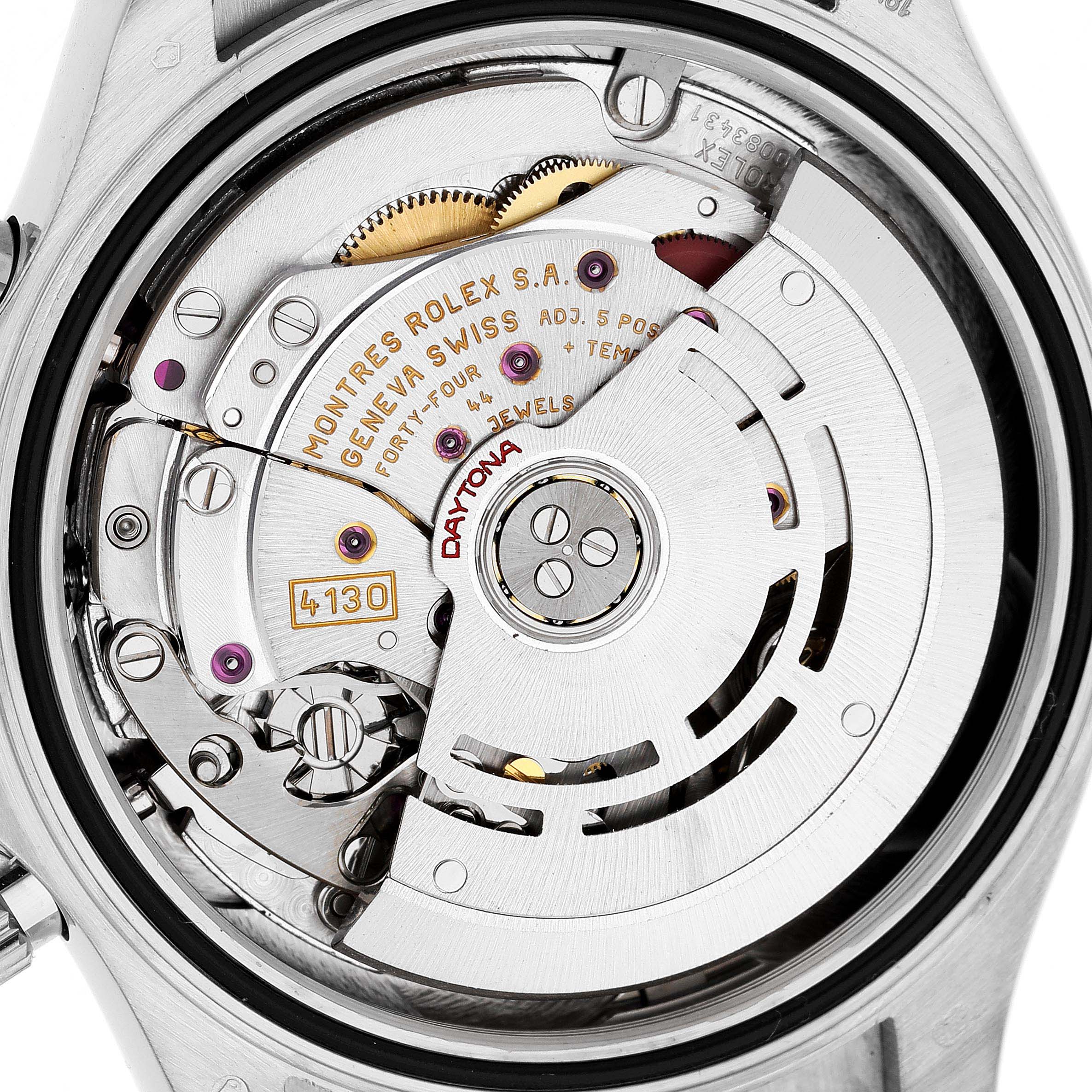 The image shows the movement mechanism of a Rolex Daytona 116519 Men's White Gold Silver Dial watch, displaying the rotor and intricate watch components.