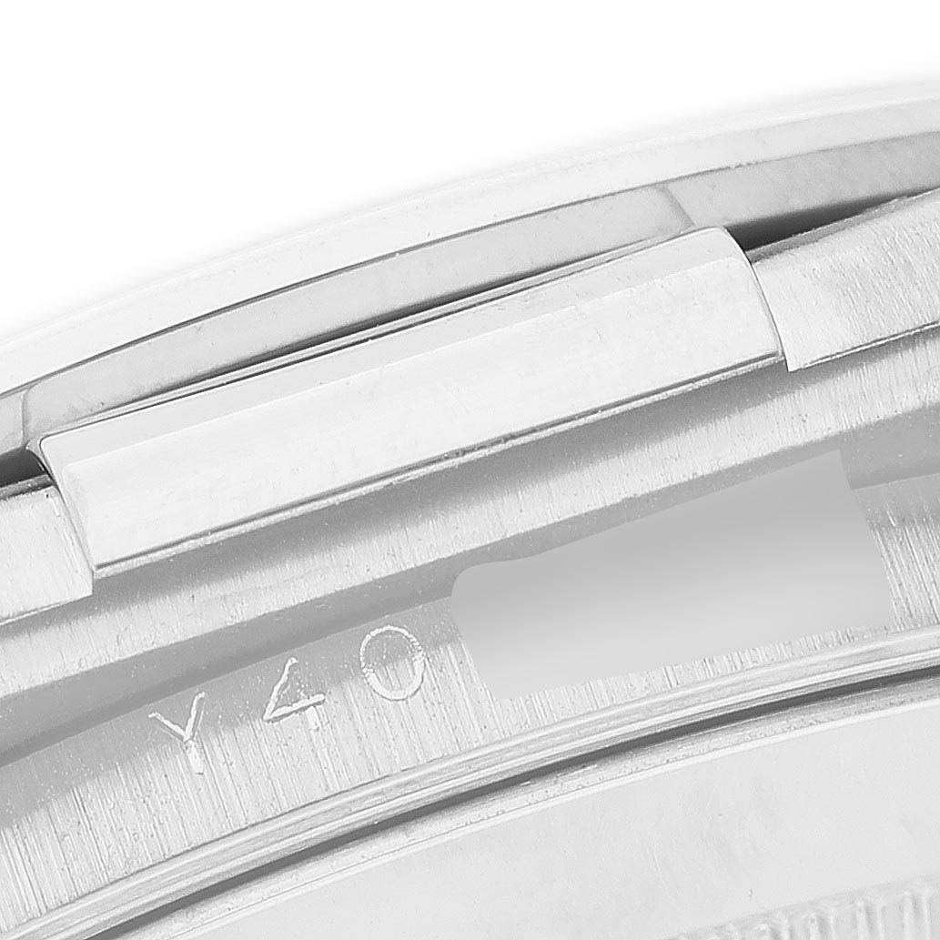 The image shows a close-up of the clasp and engraved detail on a Rolex Daytona 116519 Men's White Gold Silver Dial watch.