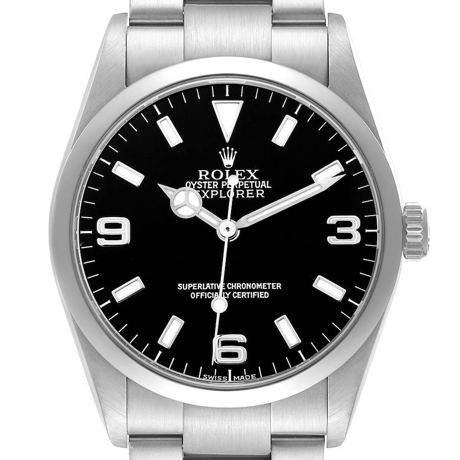 The Rolex Explorer watch is shown from the front, displaying its black dial, hour markers, and hands, with part of the metal bracelet visible.