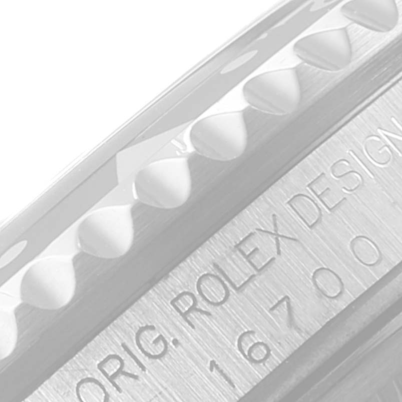 The image shows a close-up view of the edge of the bezel and case engraving on a Rolex GMT-Master 16700 Men's Stainless Steel Black Dial 16700 Men's Stainless Steel Black Dial watch.