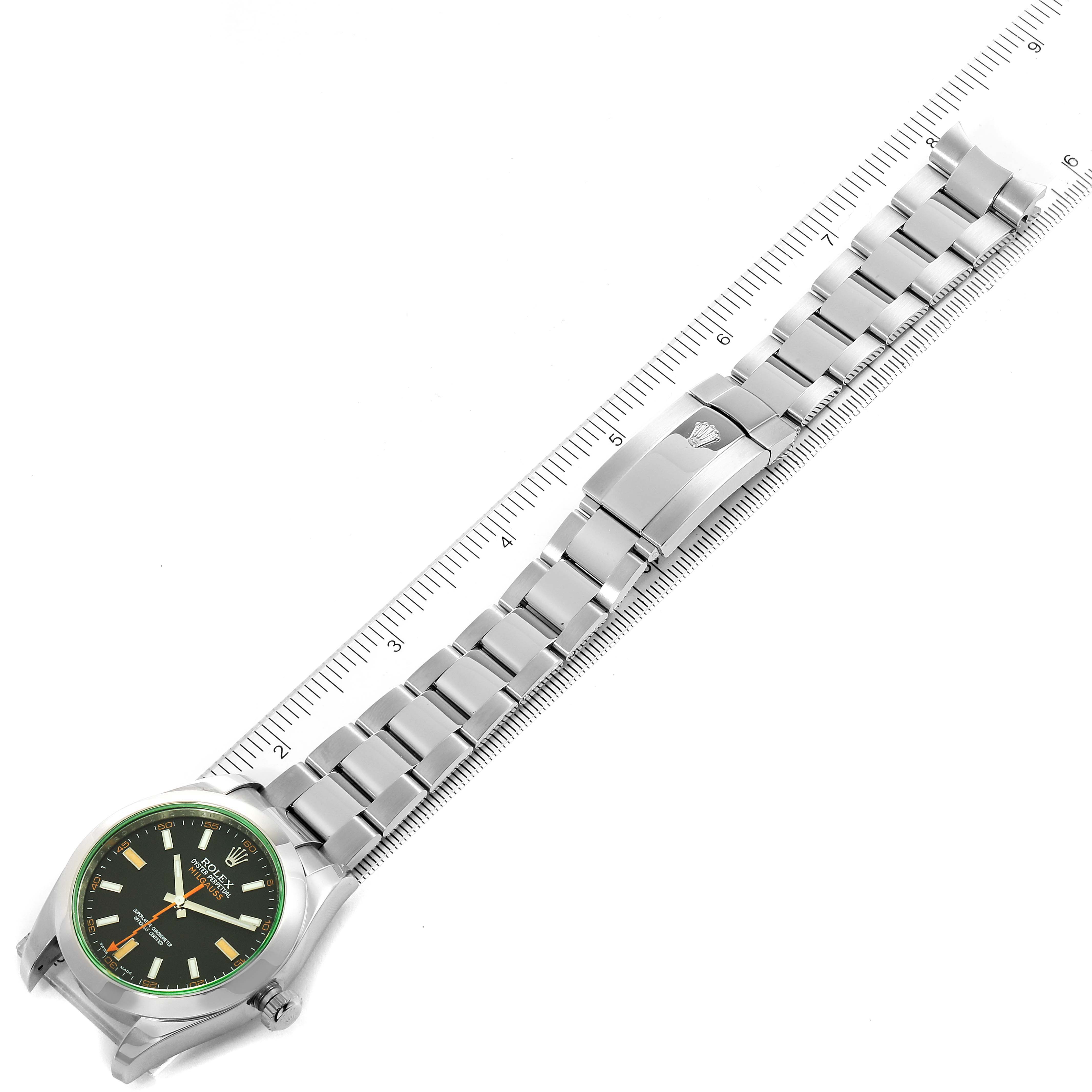 This image shows a Rolex Milgauss 116400V Men
s Stainless Steel Black Dial 116400V Men
s Stainless Steel Black Dial watch laid flat with the bracelet fully extended under a ruler.