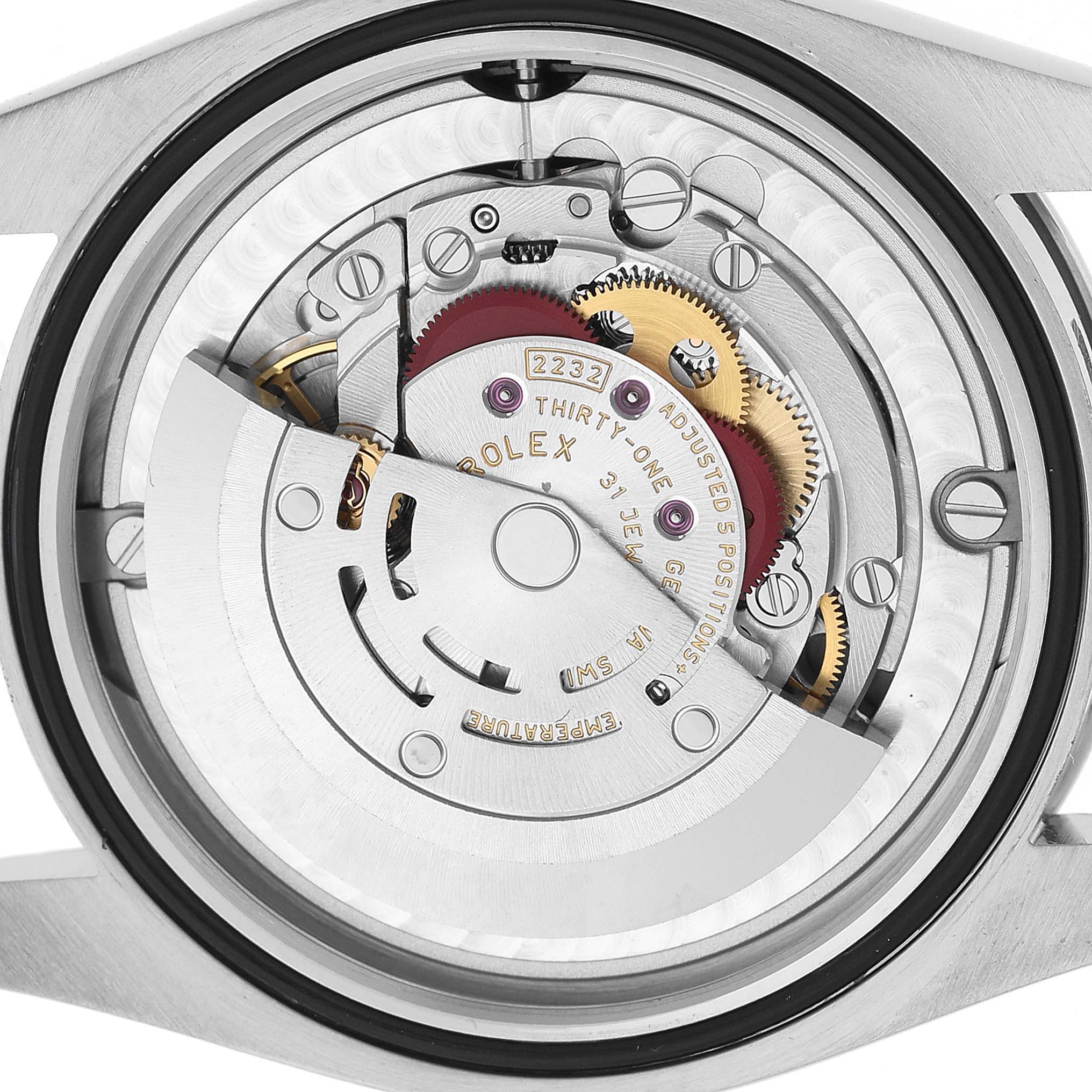 The image shows the movement of a Rolex Oyster Perpetual M124200-0002 Men's Stainless Steel Black Dial watch from the back, highlighting gears and the rotor.