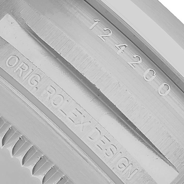 The image shows the engraved model and design information on the case back of a Rolex Oyster Perpetual M124200-0002 Men's Stainless Steel Black Dial watch.