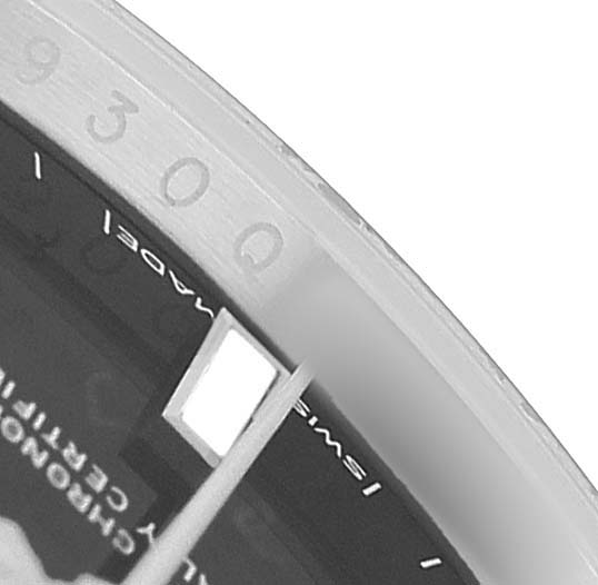 The image shows a close-up of the dial and watch hands of a Rolex Oyster Perpetual M124200-0002 Men's Stainless Steel Black Dial, focusing on hour markers and text details.