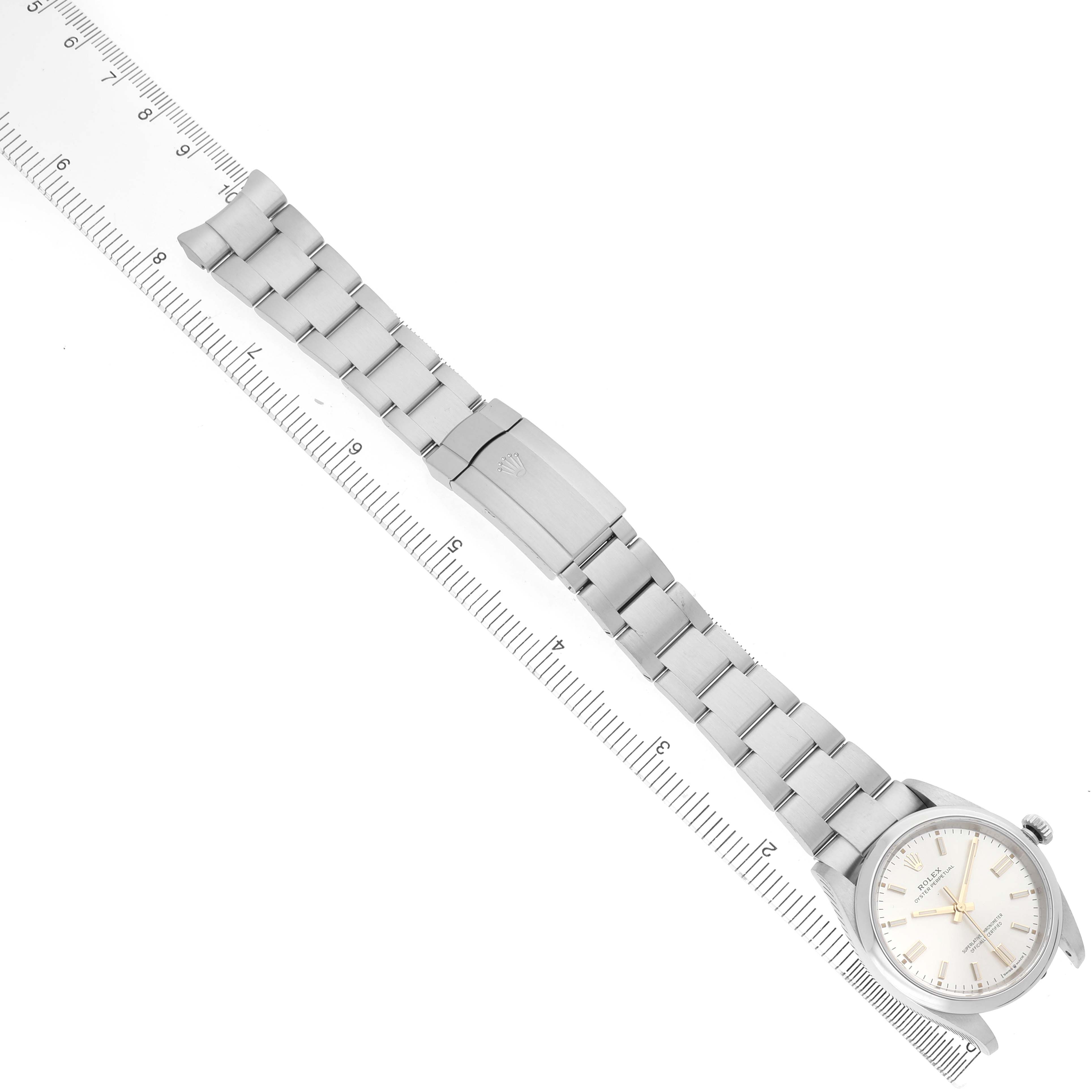 The image shows the Rolex Oyster Perpetual 126000 Men's Stainless Steel Silver Dial watch laid flat with a full view of the bracelet, clasp, and watch face.