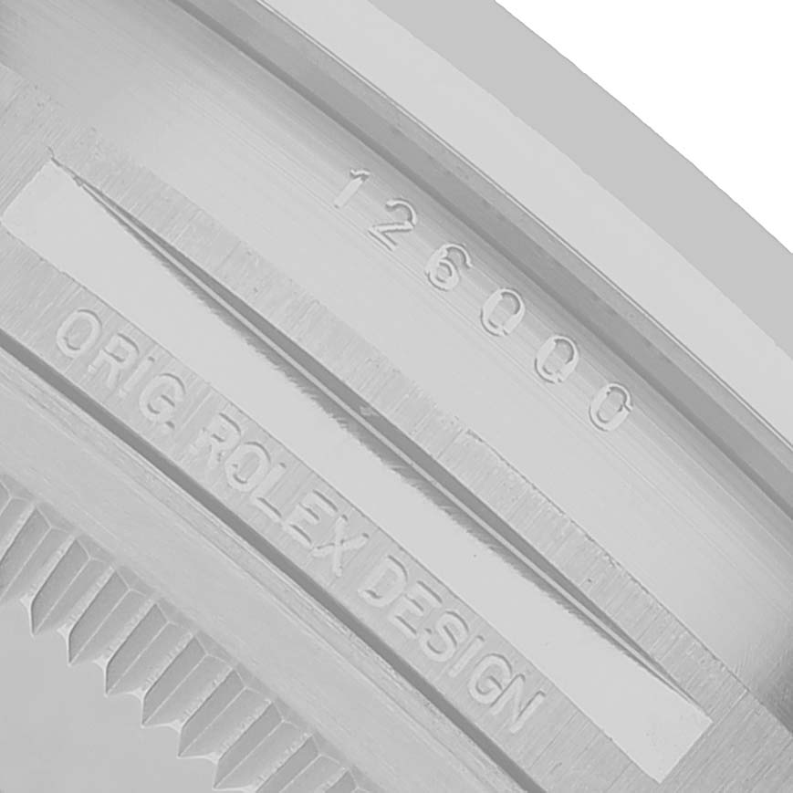 The image shows a close-up of the side engraving on a Rolex Oyster Perpetual 126000 Men's Stainless Steel Pink Dial with the model and design text visible.